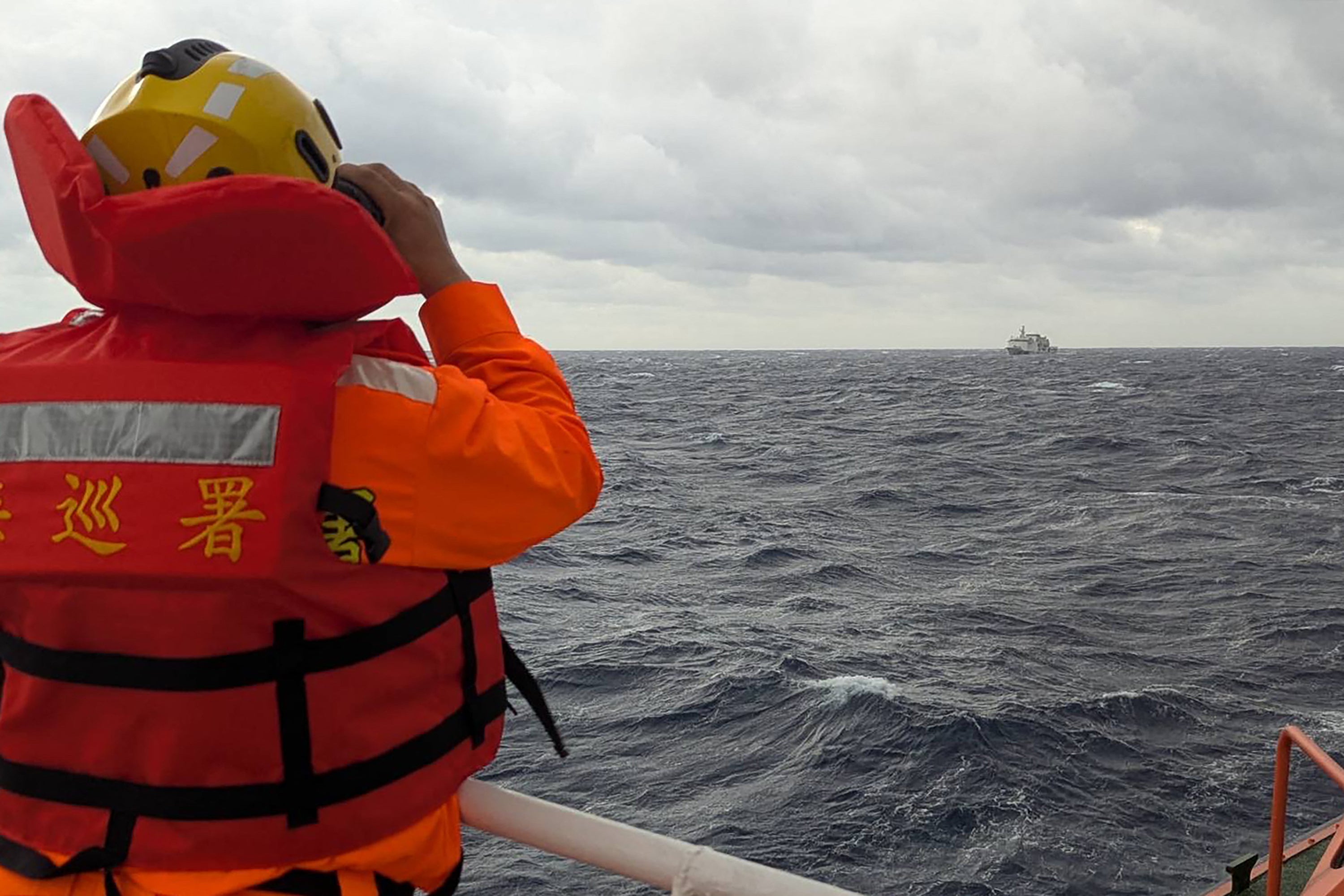 A Taiwanese coast guard ship monitors a Chinese vessel in the waters east of Taiwan