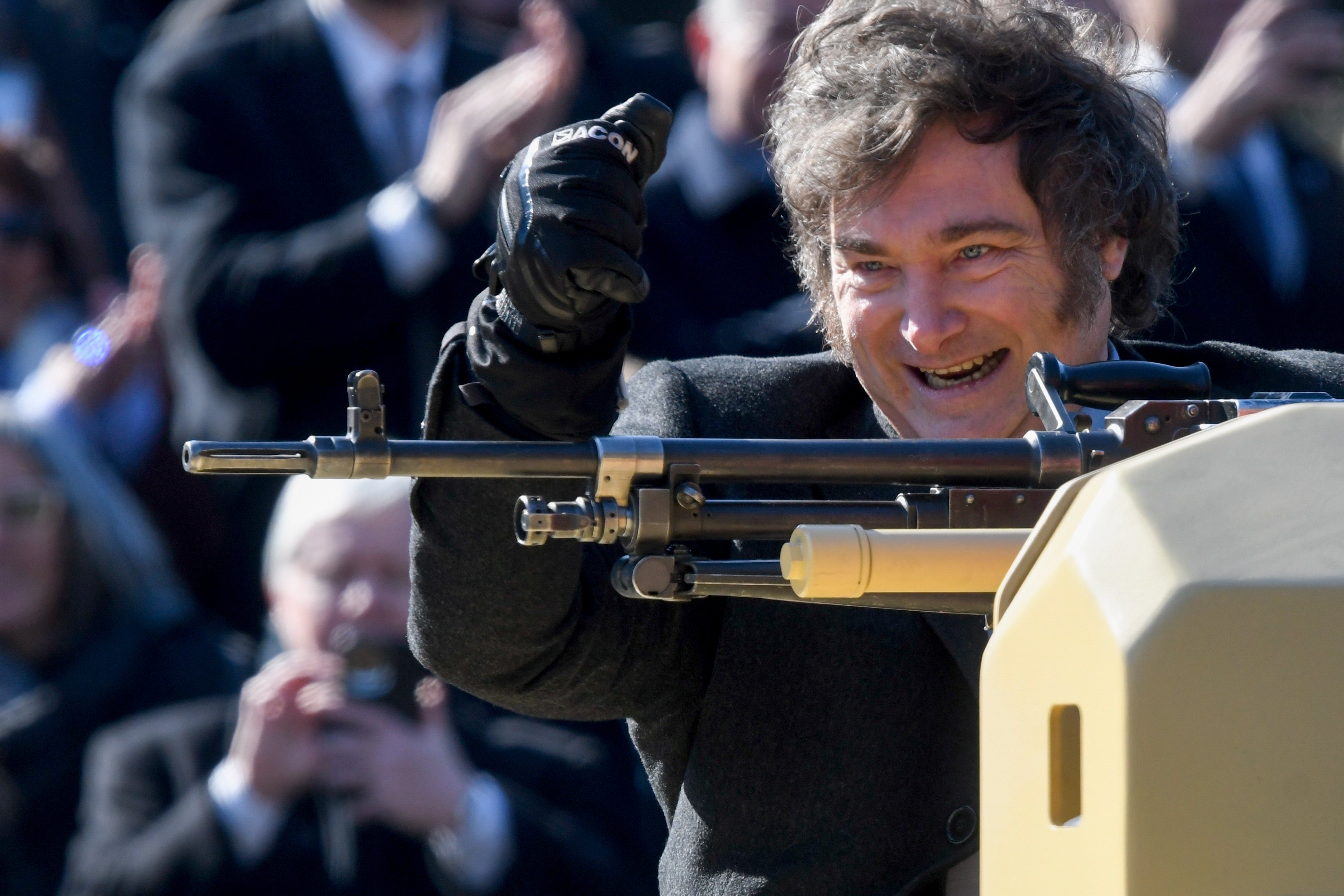 Argentine President Javier Milei stands on an armored tank during a military parade