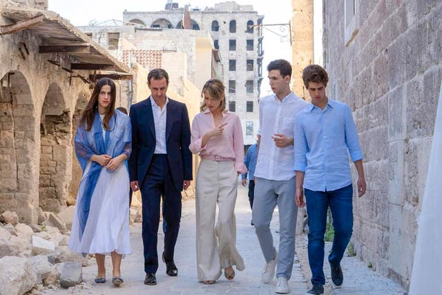 <p>Syria’s former president Bashar al-Assad and his wife Asma walking with their children, Hafez, Karim and Zein next to the Grand Umayyad mosque in the northern Syrian city of Aleppo</p>