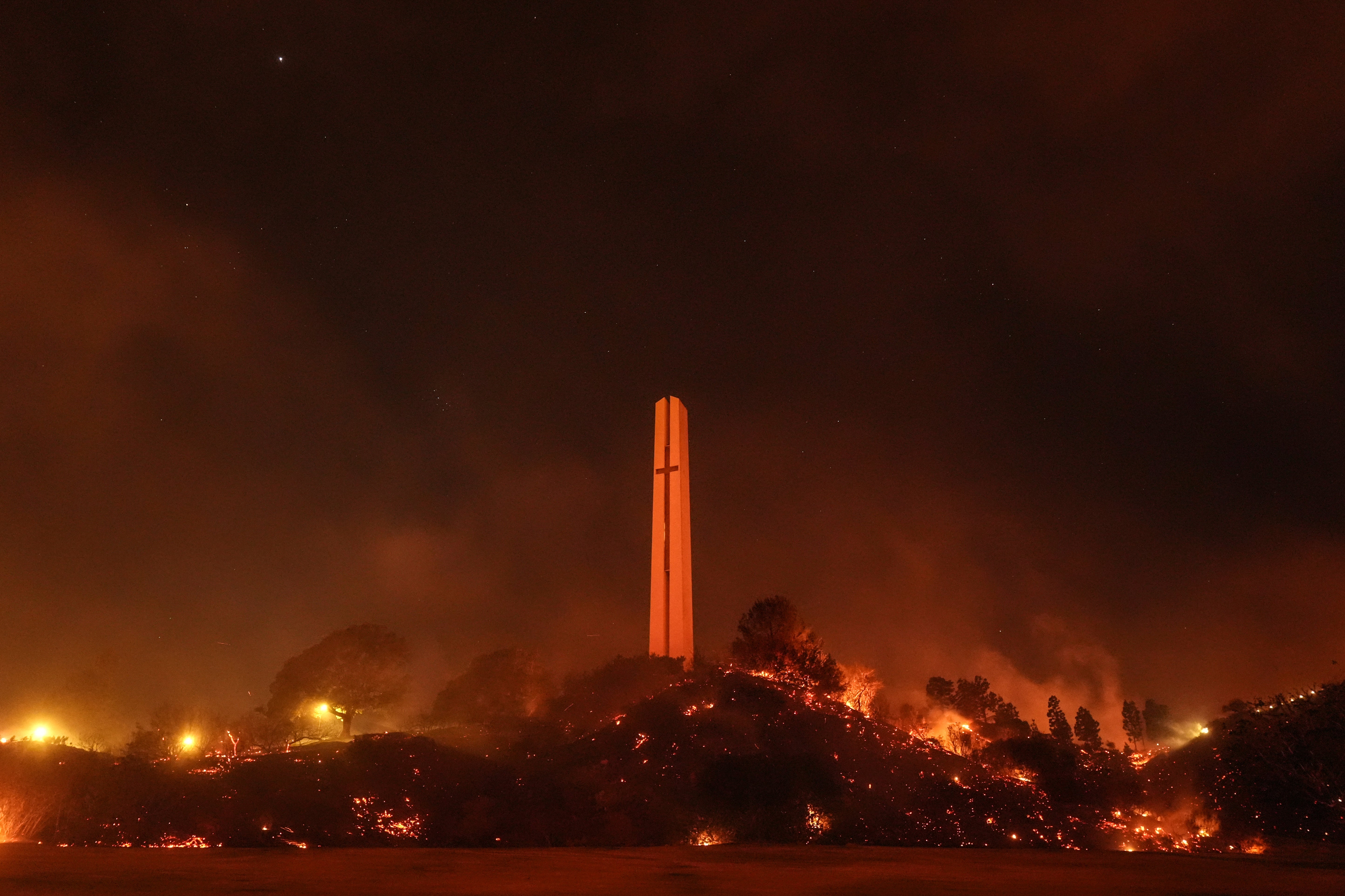 Vegetation around Pepperdine University’s iconic Phillips Theme Tower is scorched on Tuesday by the Franklin Fire in Malibu, California. The university was sheltering in place