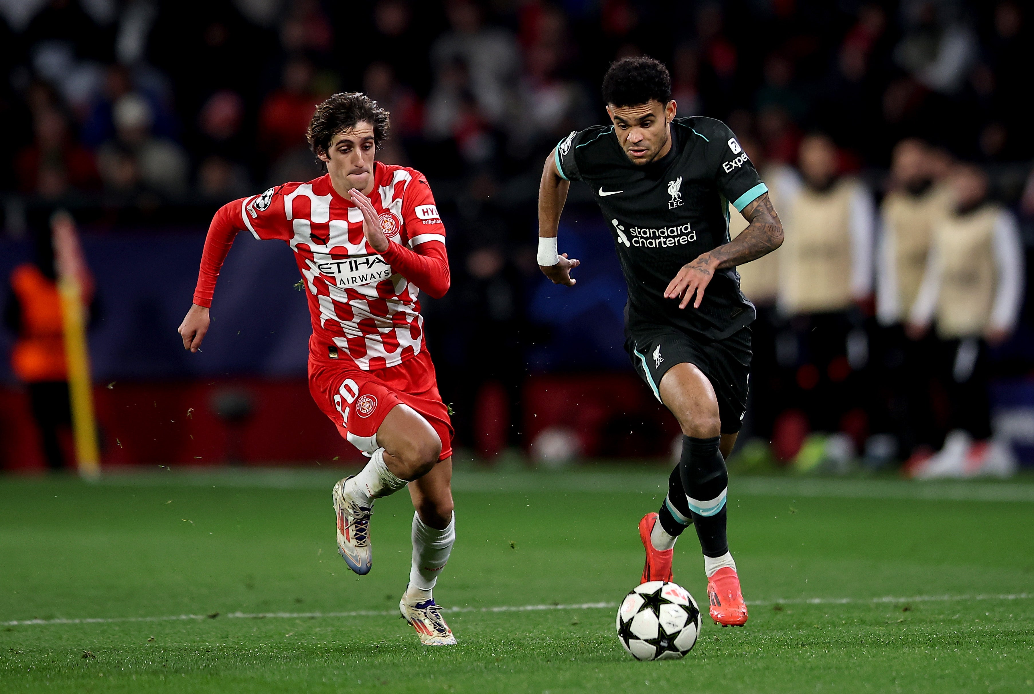 Luis Diaz of Liverpool runs with the ball under pressure from a Girona player