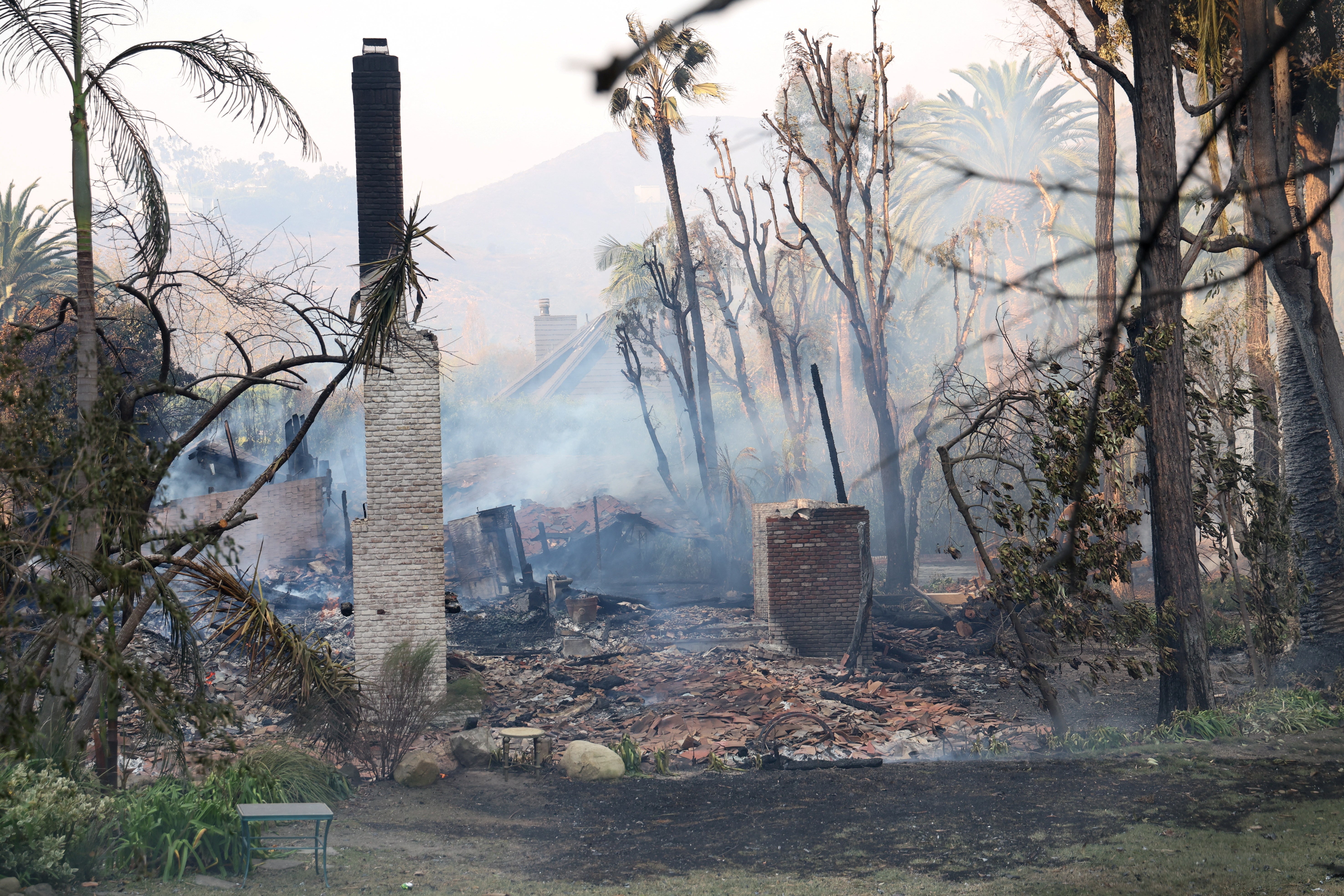 The remains of a house are seen on Tuesday in Malibu, California. Windy weather fanned the wildfire’s flames