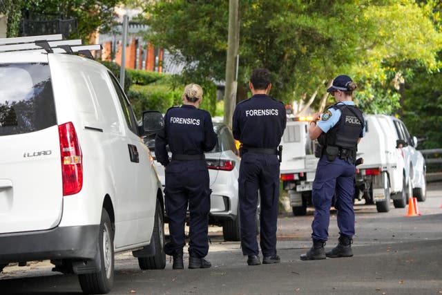 <p>Police stand near houses vandalized with anti-Israel slogans in Sydney suburb of Woollahra, Australia, Wednesday, 11 Dec 2024</p>