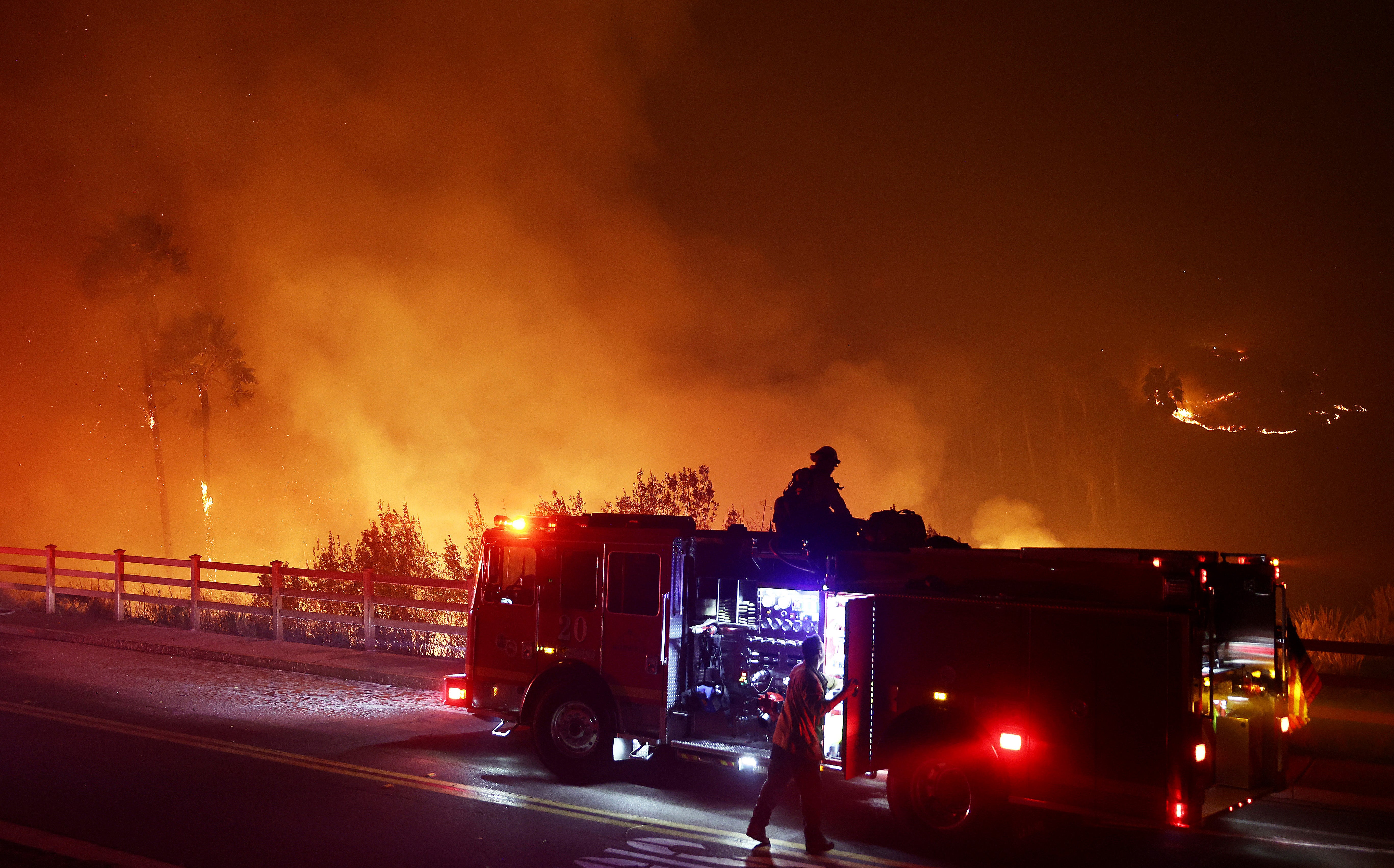 Firefighters work as the Franklin Fire burns in Malibu, California