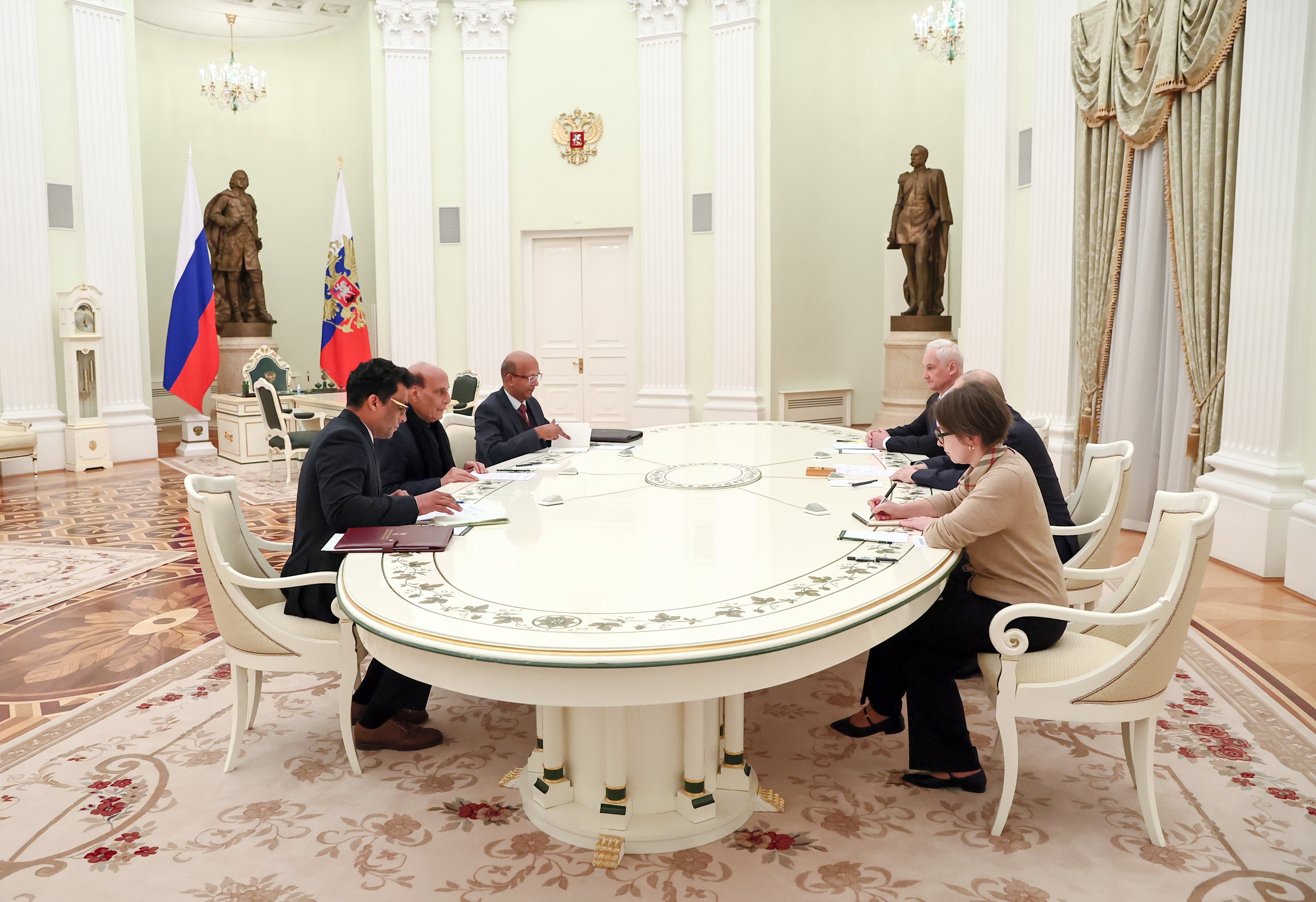 Vladimir Putin and Indian defence minister Rajnath Singh attend a meeting at the Kremlin in Moscow