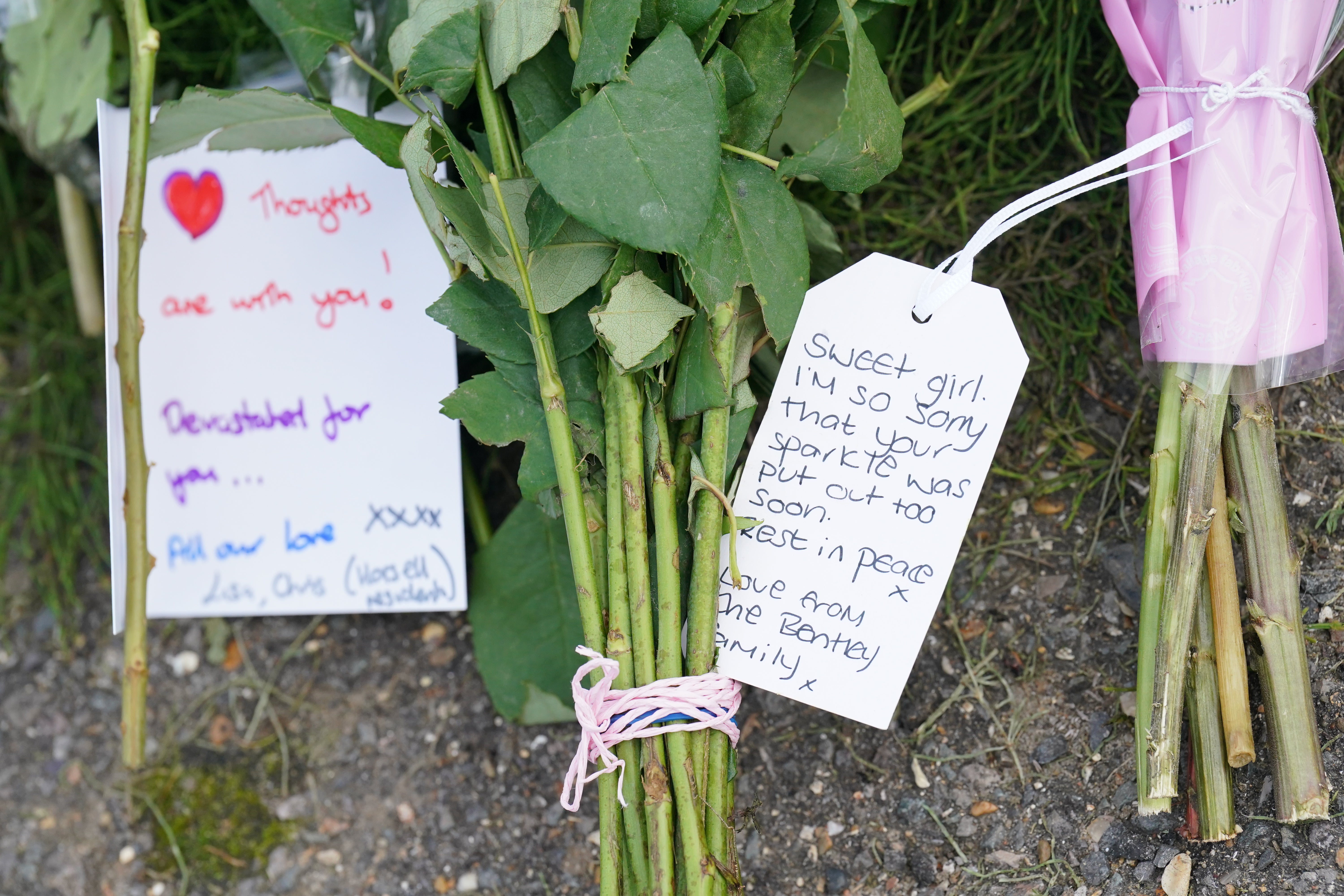 Flowers and notes left outside Sara Sharif’s home in Hammond Road in Woking