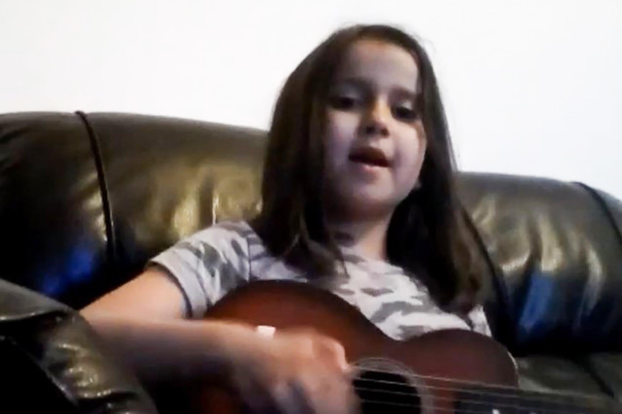 After the trial, police also released footage of Sara sitting on a black leather sofa, singing and playing guitar