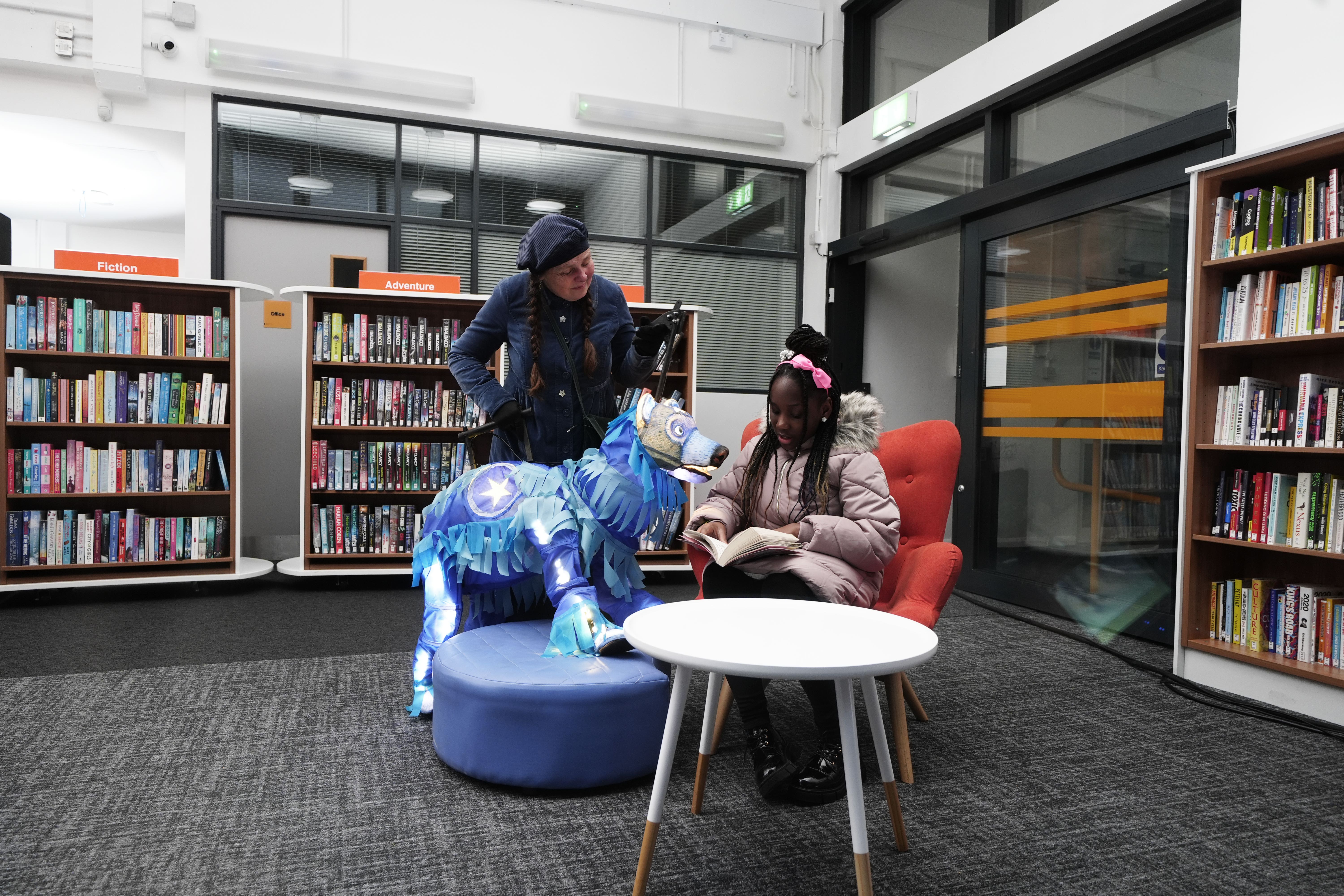 Pearl Ogunyadeka, 10, reading a book inside Spellow Community Hub and Library in Walton, as it reopens (Peter Byrne/PA)