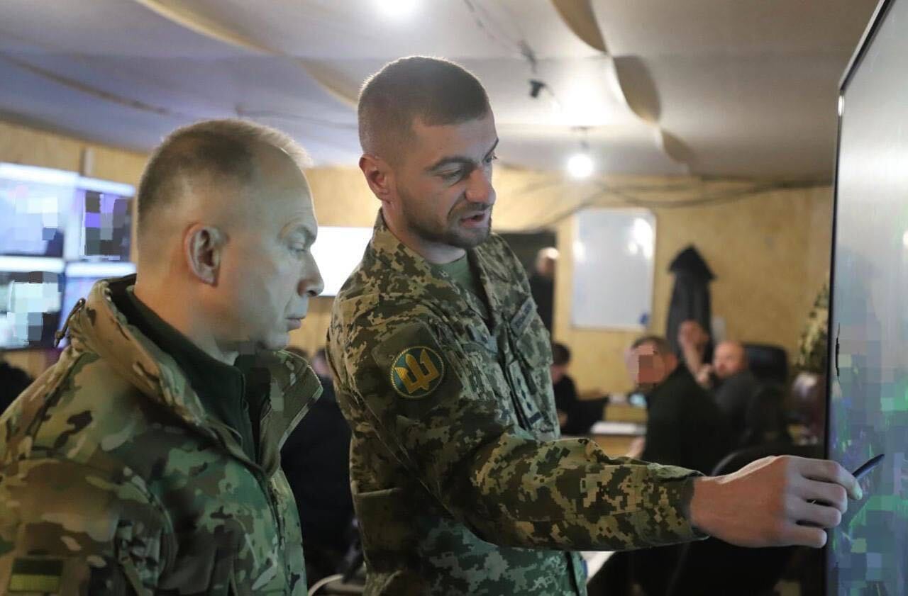 Ukrainian military chief Oleksandr Syrskyi, left, speaks to a member of the 38th Separate Brigade in Pokrovsk