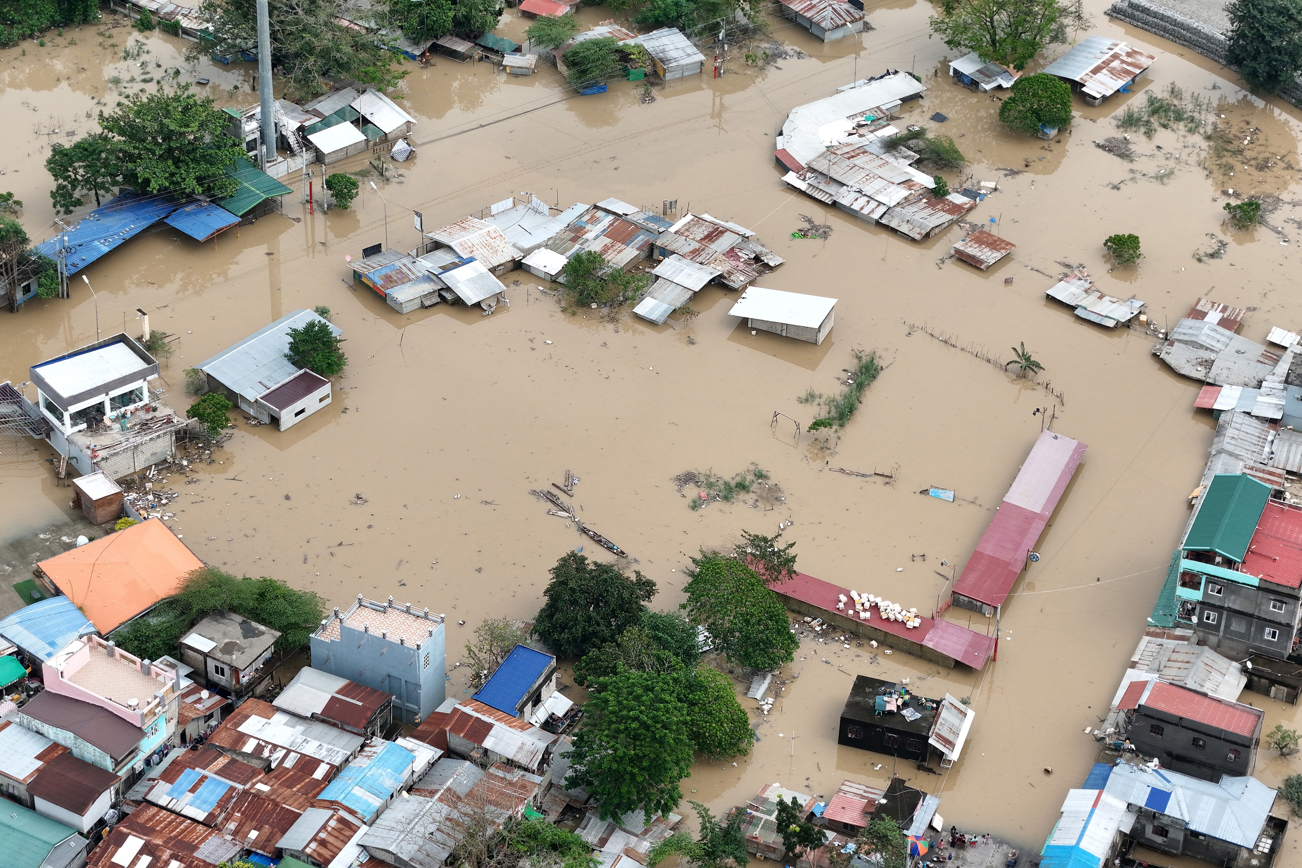An aerial view shows inundated houses after a river overflow due to floodings caused by heavy rains and induced by Super Typhoon Man-yi in Tuguegarao City, Cagayan province
