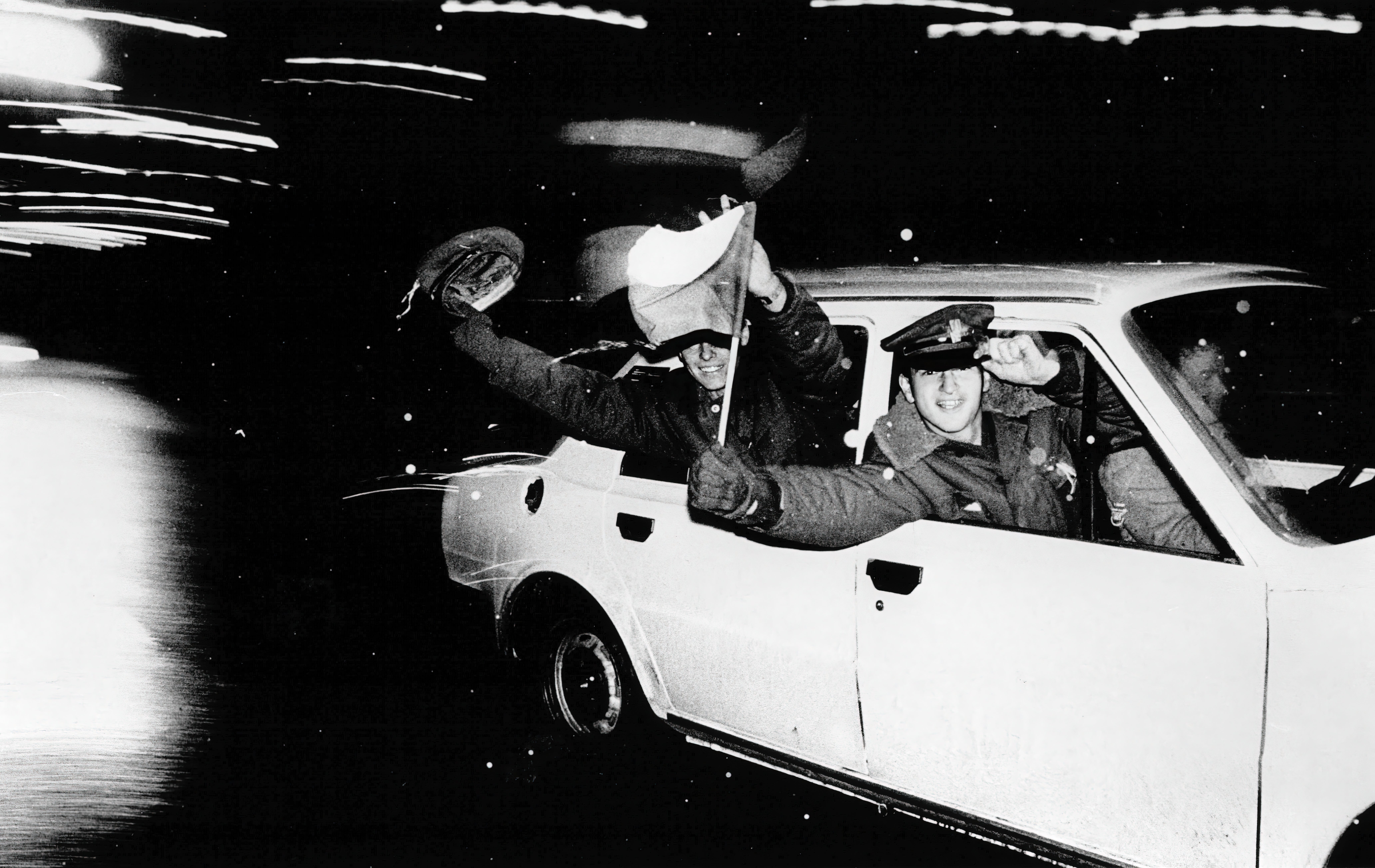 Young men celebrate in Prague after fall of the Czech government, 1989