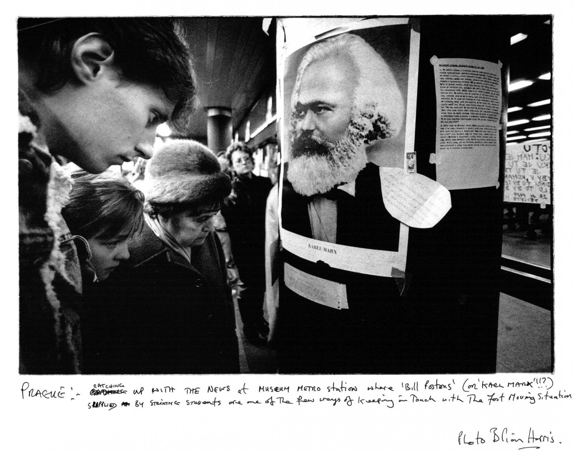 Catching up with the ‘fast-moving situation’, people read updates pinned up by striking students at Museum Metro Station, Prague