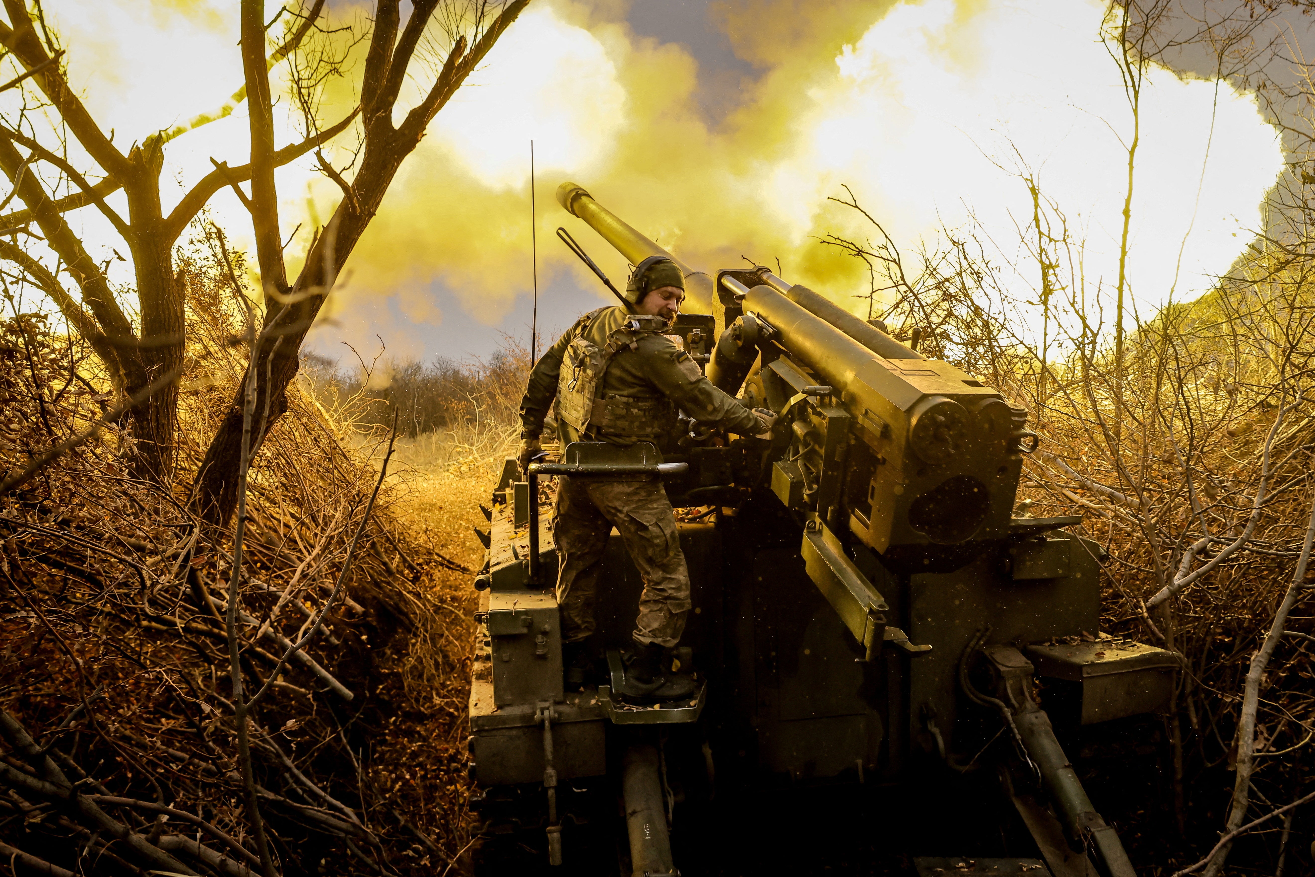 A Ukrainian soldier fires a self-propelled howitzer towards Russian troops at a front line in Donestk