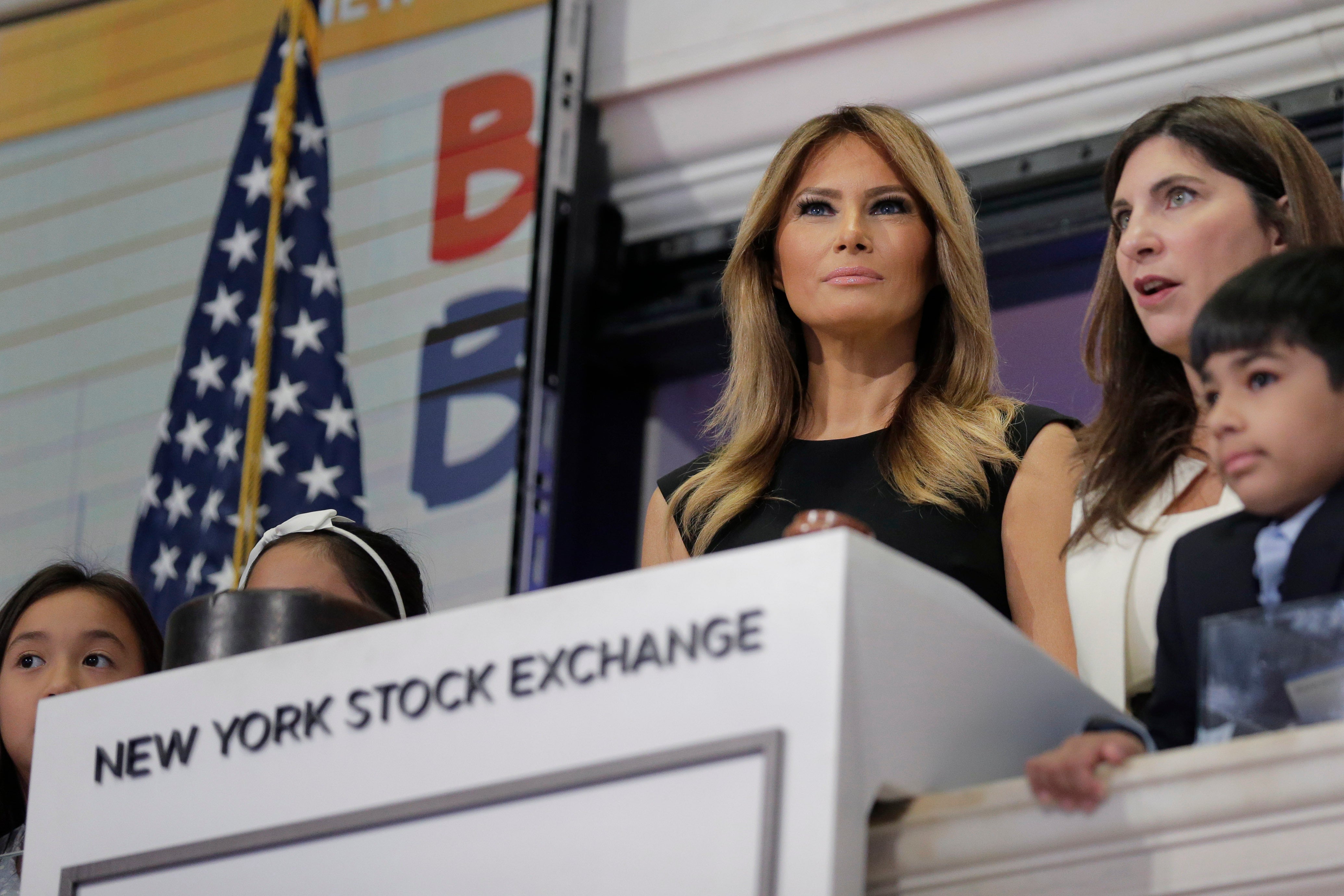New York Stock Exchange President Stacey Cunningham, right, and first lady Melania Trump, with the help of students from the United Nations International School, ring the opening bell of the NYSE in New York, Sept. 23, 2019.