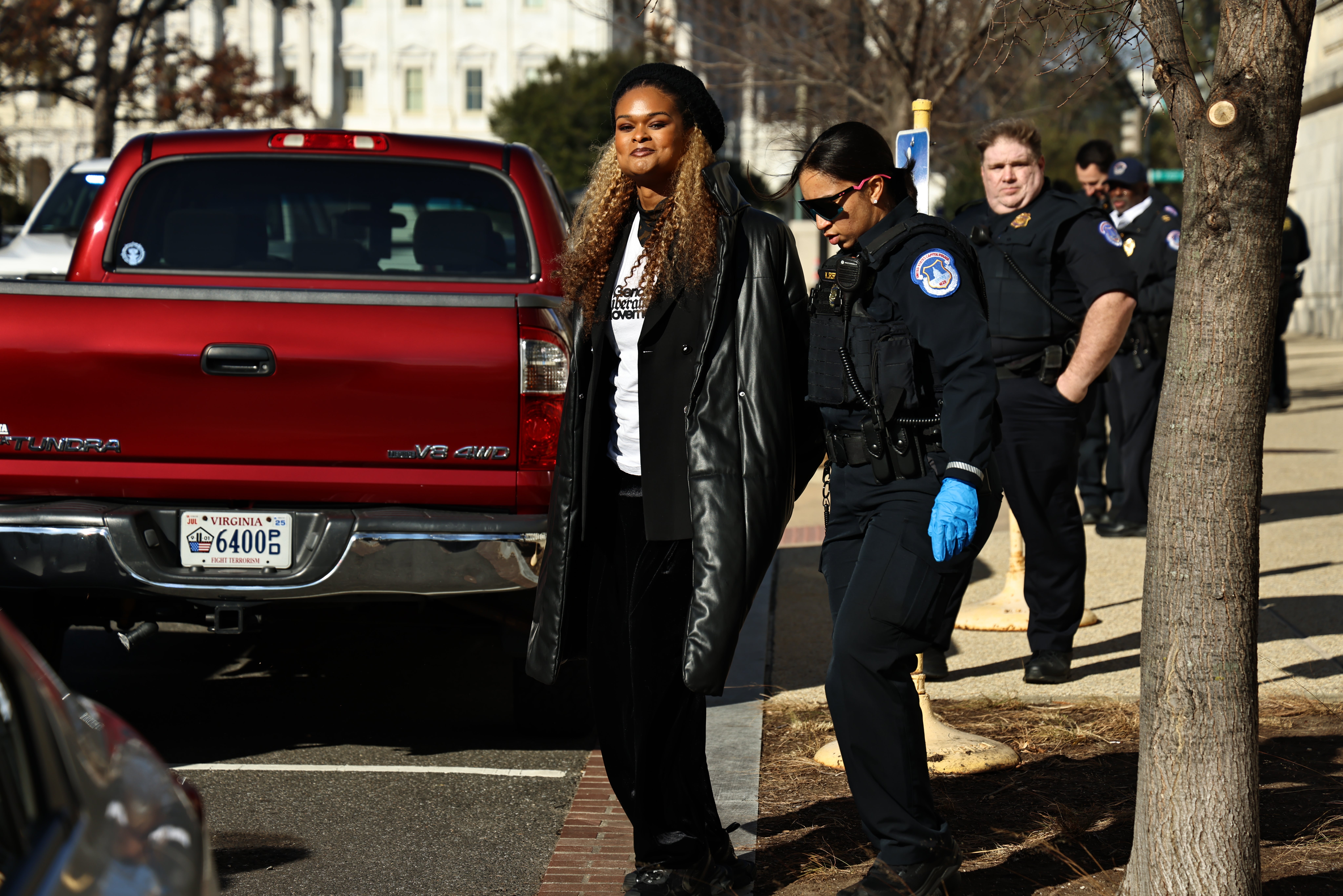 Raquel Willis, left, is arrested by Capitol police while protesting in Congress against Republicans’ trans bathroom ban on Thursday Dec 5, 2024