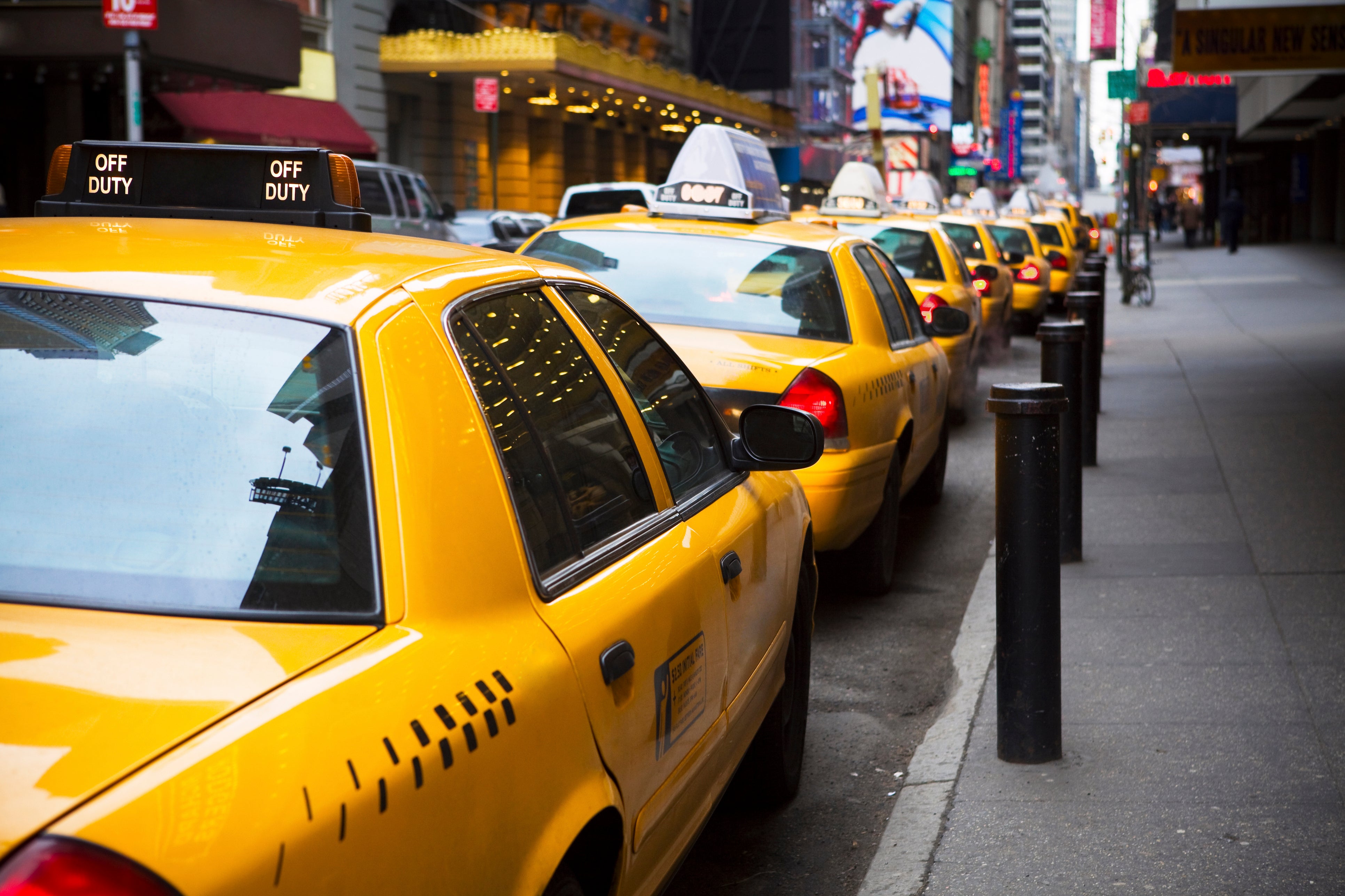 Yellow New York City cabs line up along a New York curb. Researchers found just 171 of 16,658 taxi drivers died from Alzheimer’s