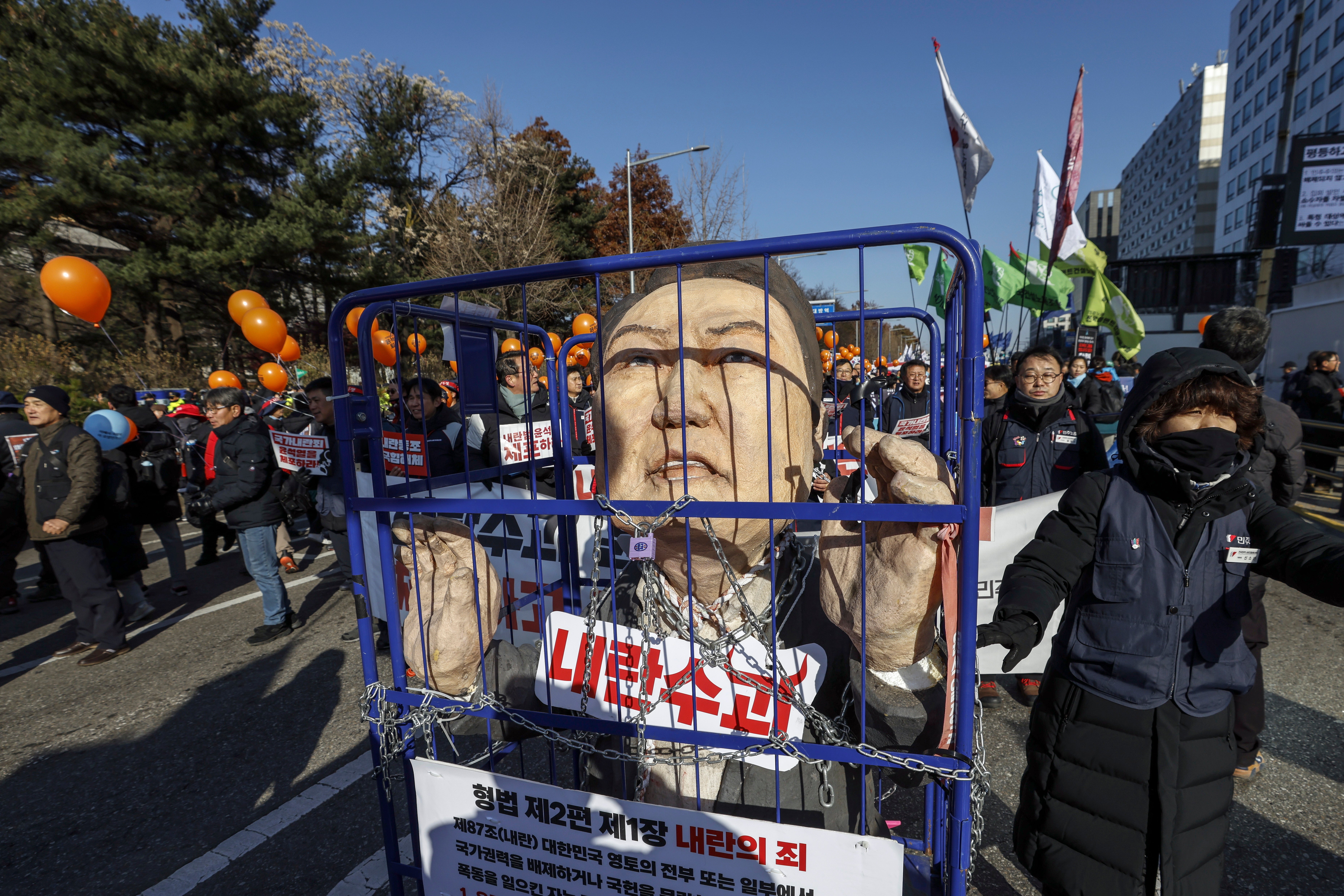 Protesters carry an effigy of South Korean president Yoon Suk Yeol during a rally calling for his impeachment outside the National Assembly in Seoul