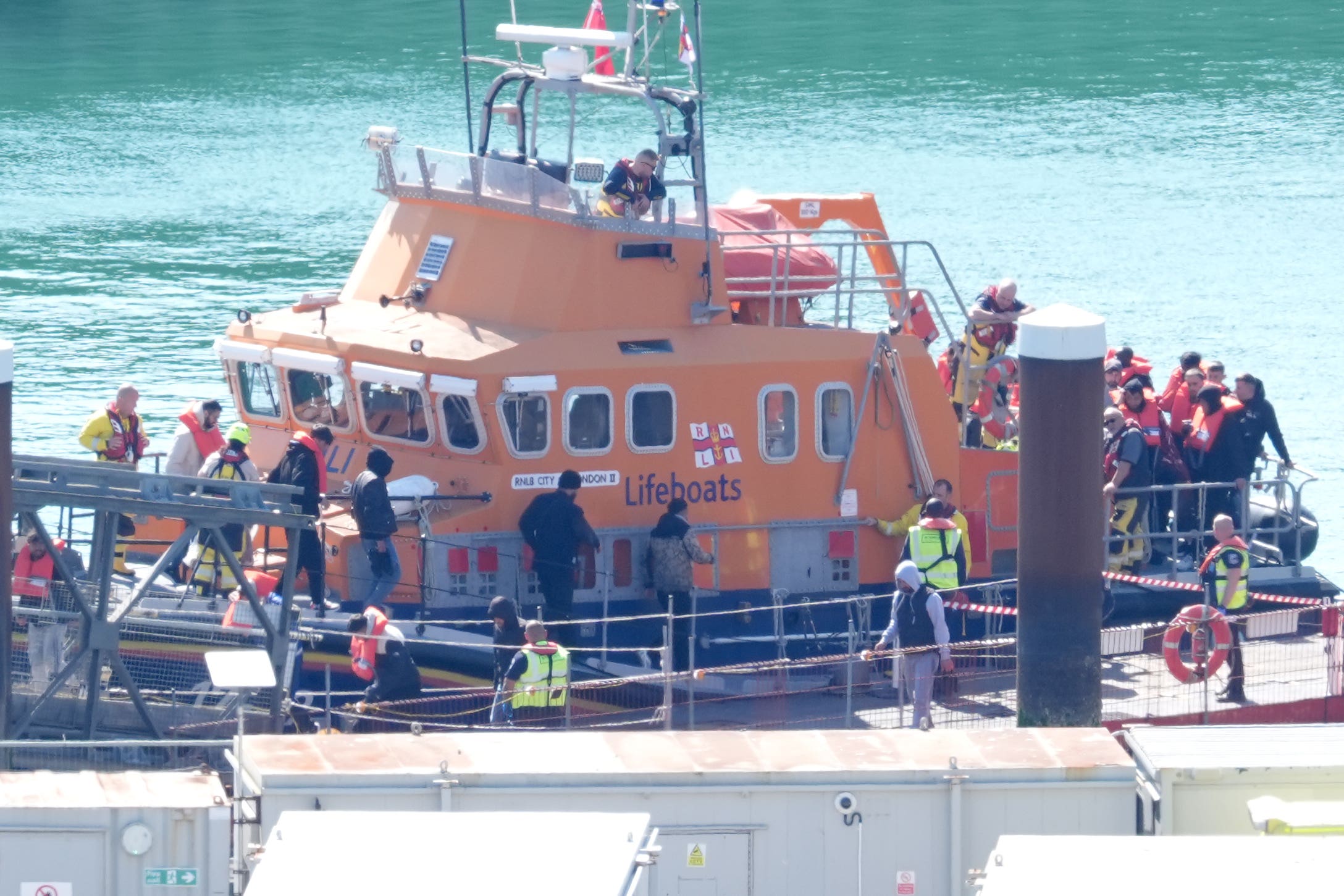 A RNLI lifeboat bring a group of people in to Dover after a small boat capsized in the English Channel in May (Gareth Fuller/PA)