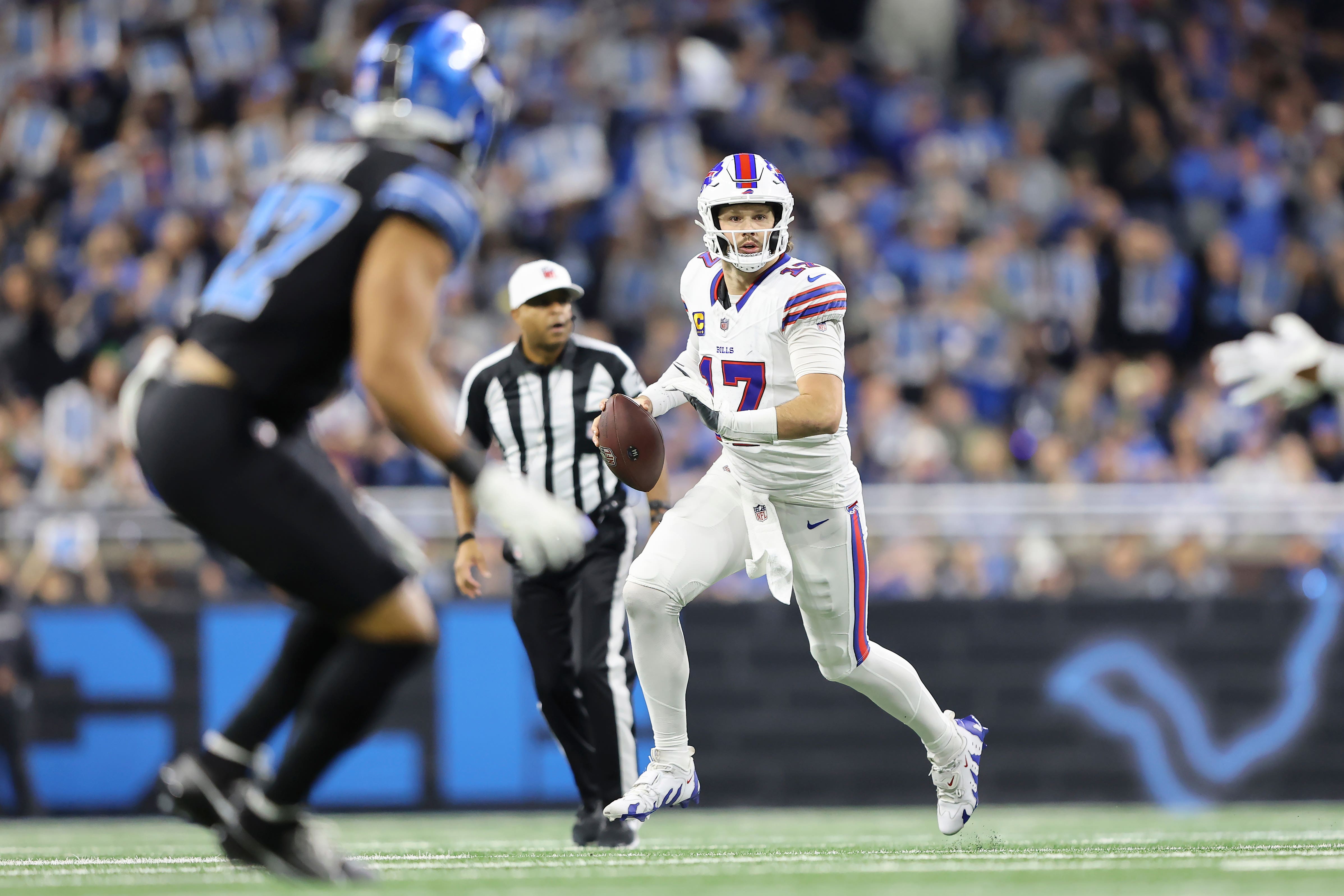 Buffalo Bills quarterback Josh Allen rolls out to pass against the Detroit Lions (Rey Del Rio/AP)