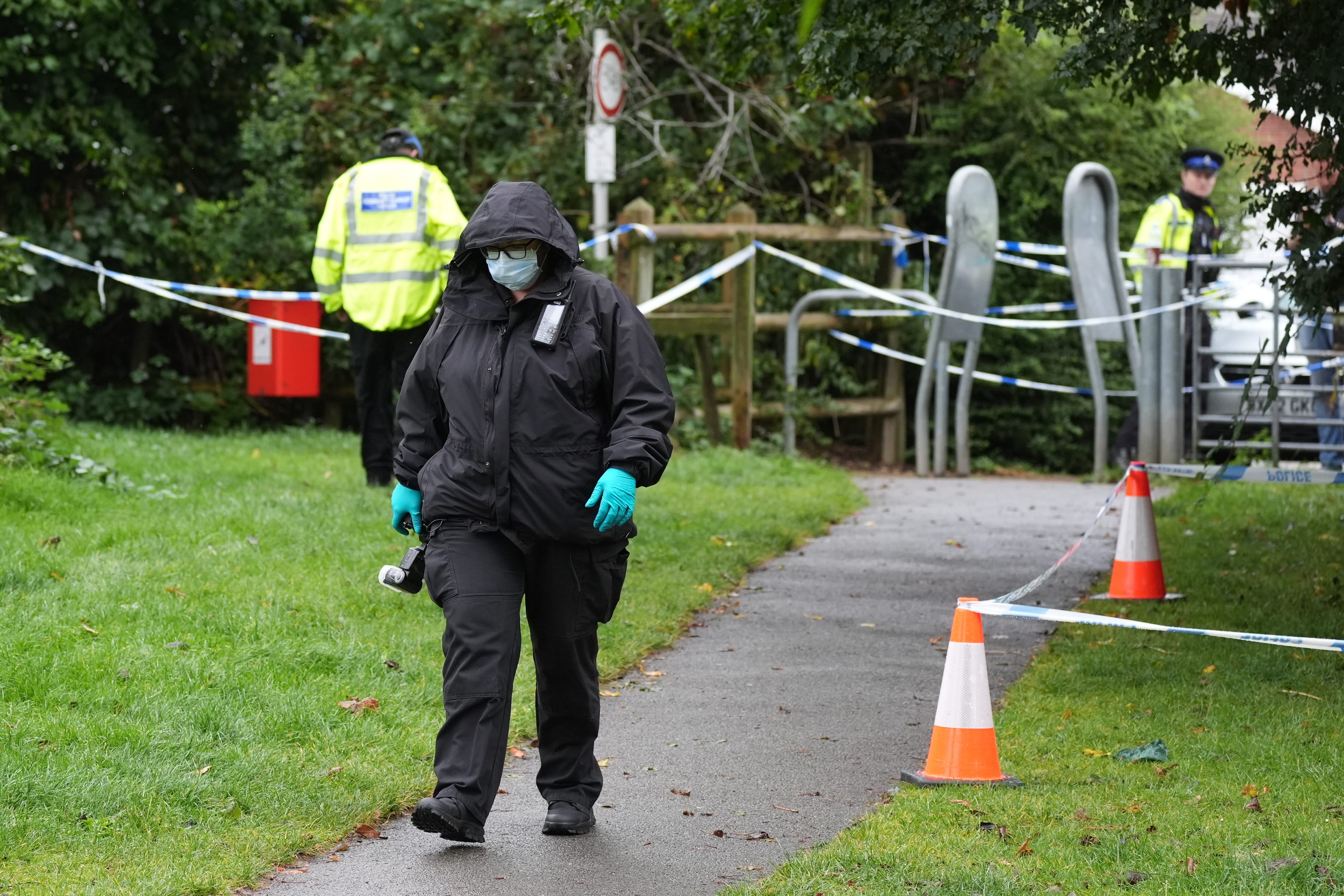 A police officer at the scene in Franklin Park where pensioner Bhim Kohli was attacked (PA)