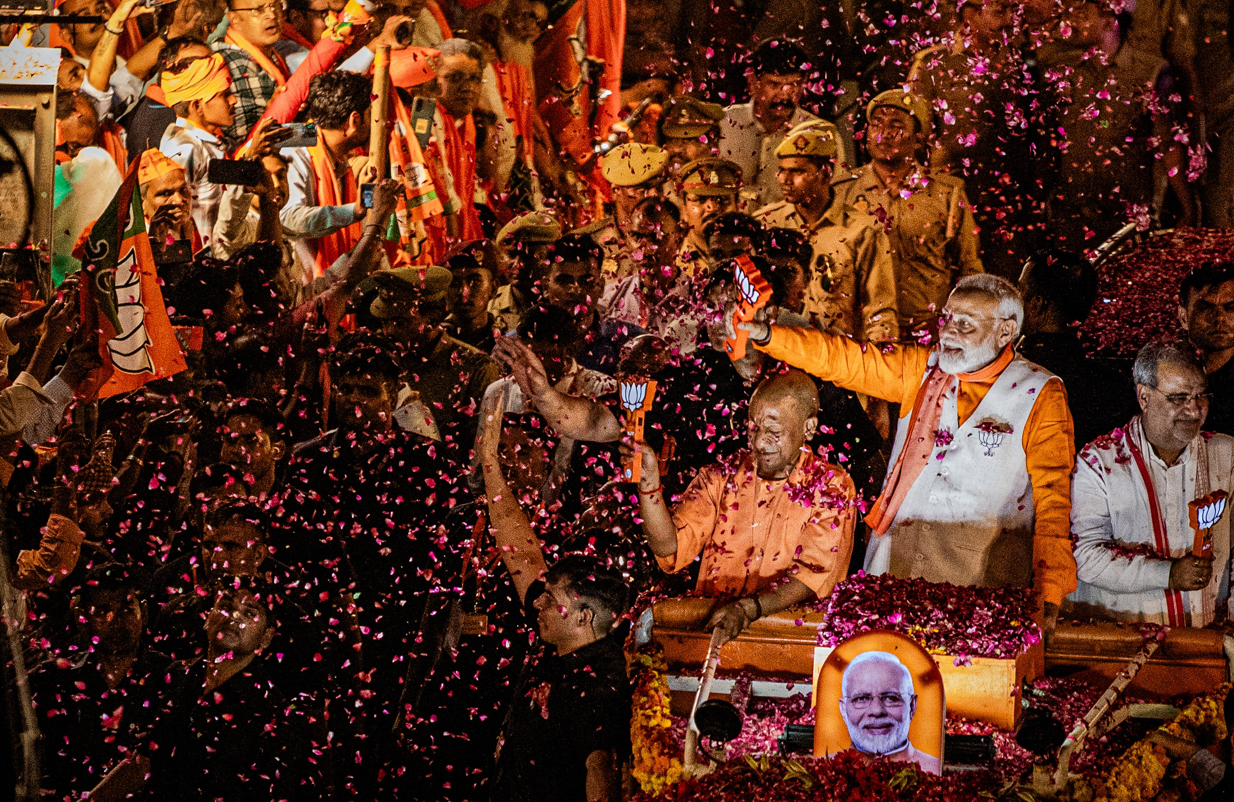 Indian prime minister Narendra Modi waves to supporters during his roadshow in India's Hindu heartland