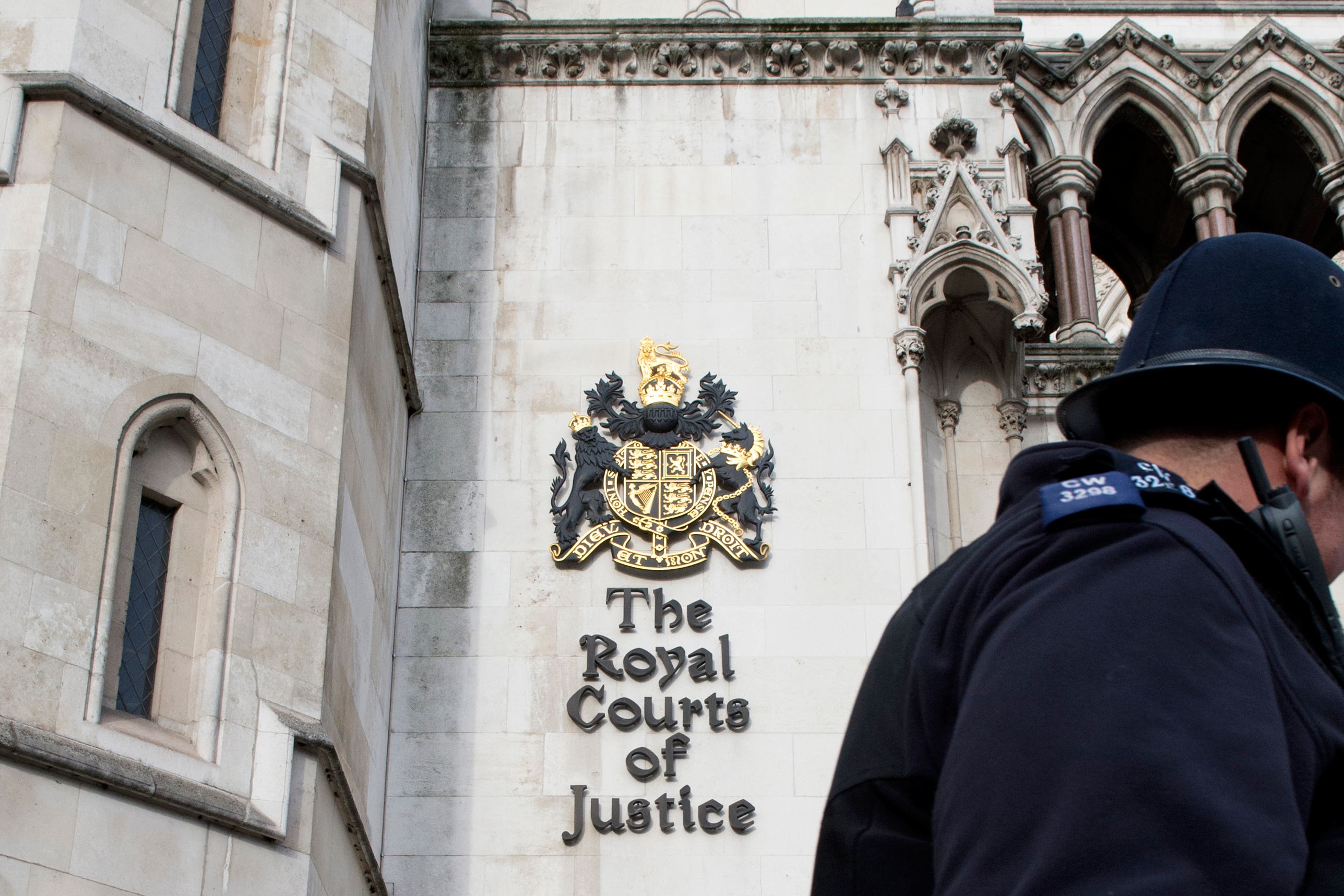 Police officers outside the Royal Courts of Justice (PA)