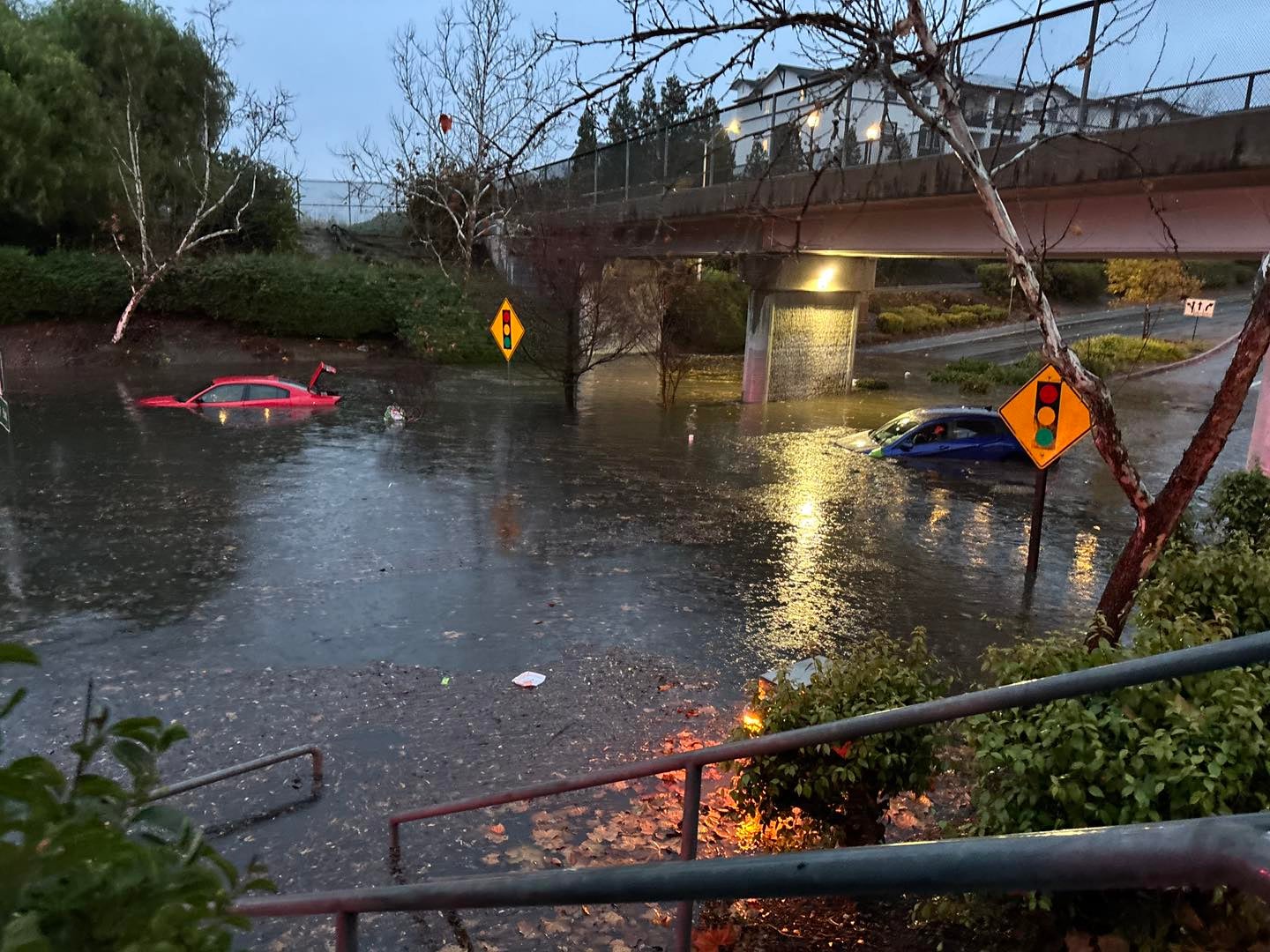 Two cars are stranded in floodwaters that fill an underpass in Livermore, California. More rain is expected in the state this week