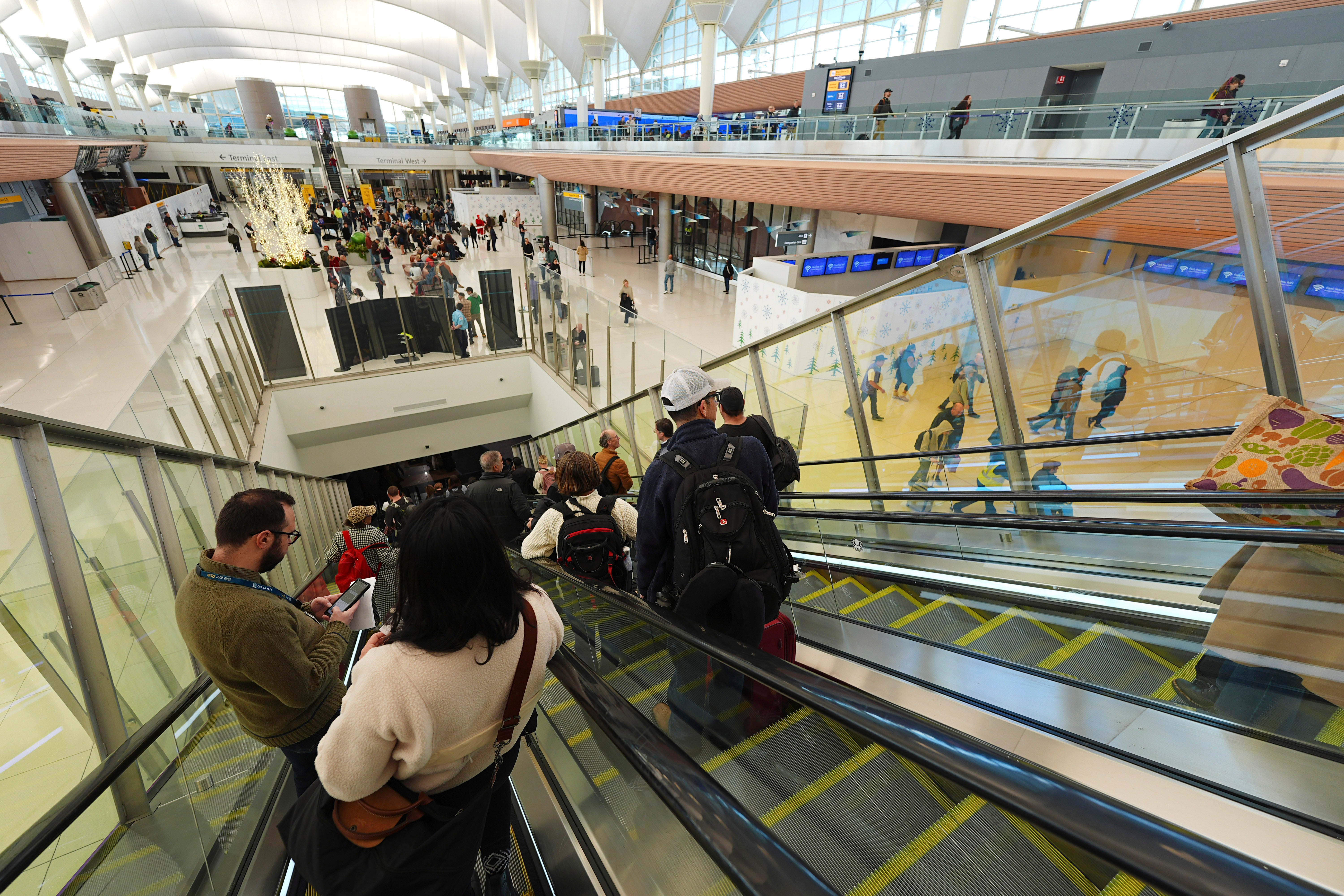 Travelers at Colorado’s Denver International Airport on Saturday. Nearly 120 million Americans are expected to travel for the holidays this month