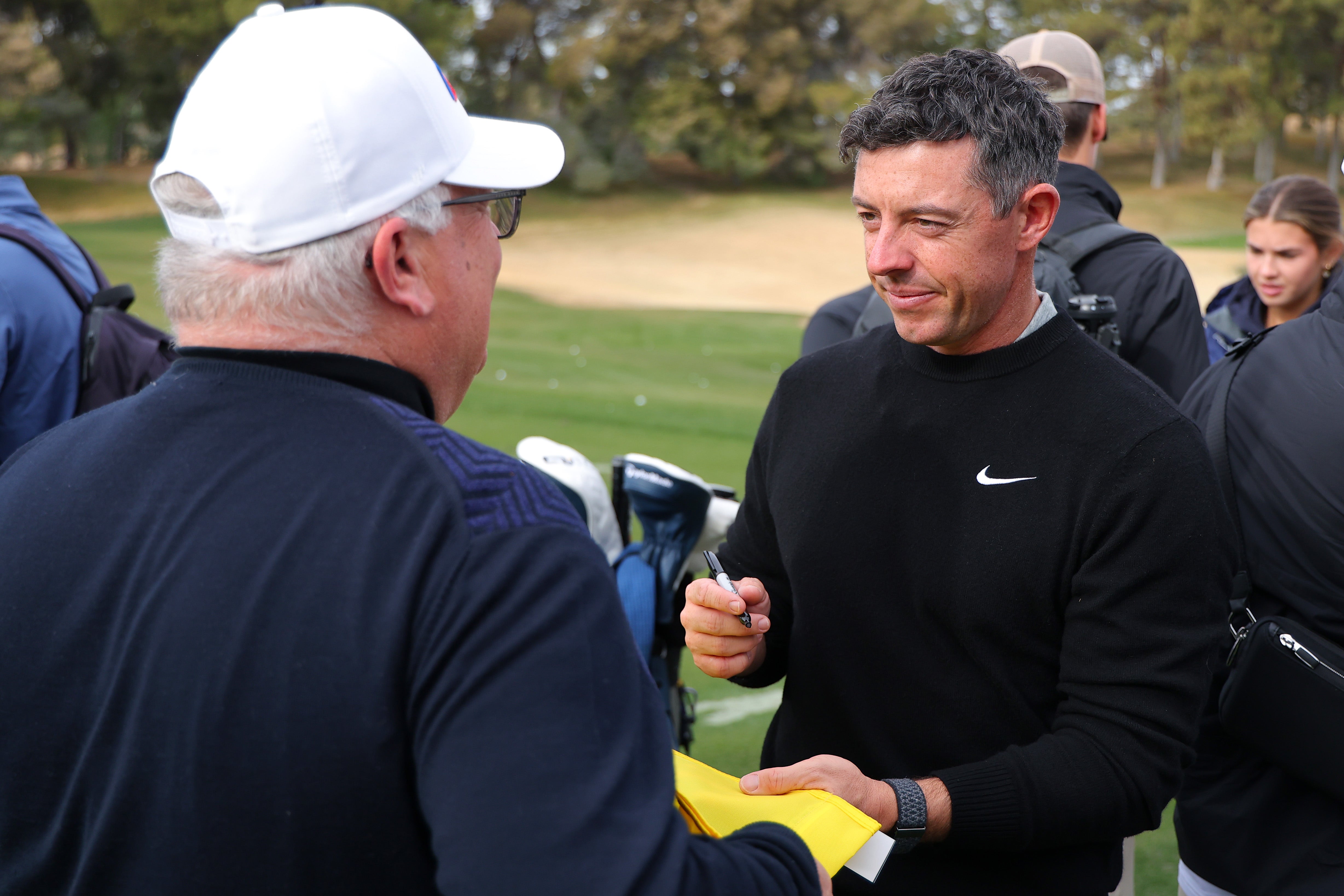 Rory McIlroy of the PGA Tour signs autographs for fans before The Showdown