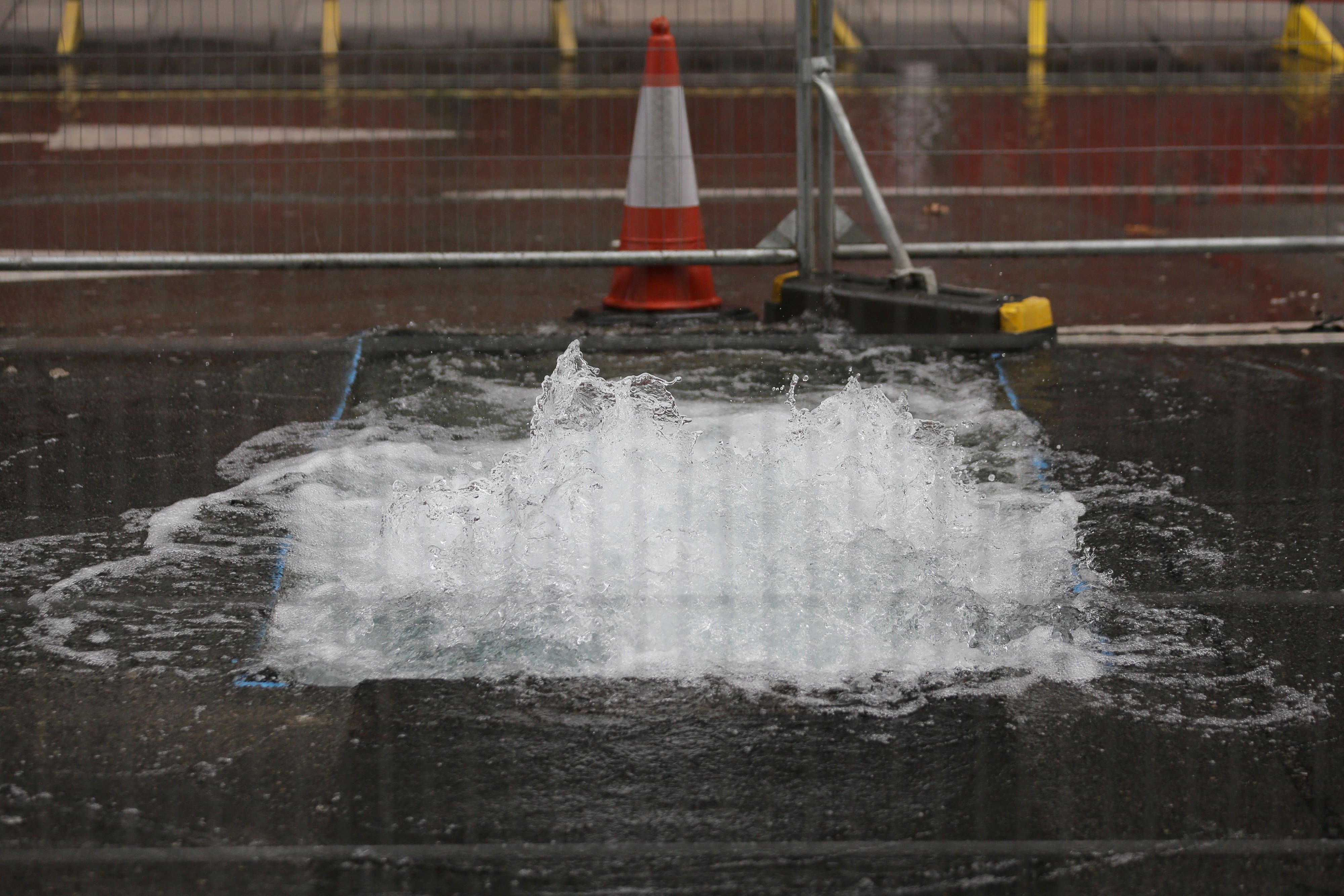 A burst water main on Victoria Street in Westminster (PA)