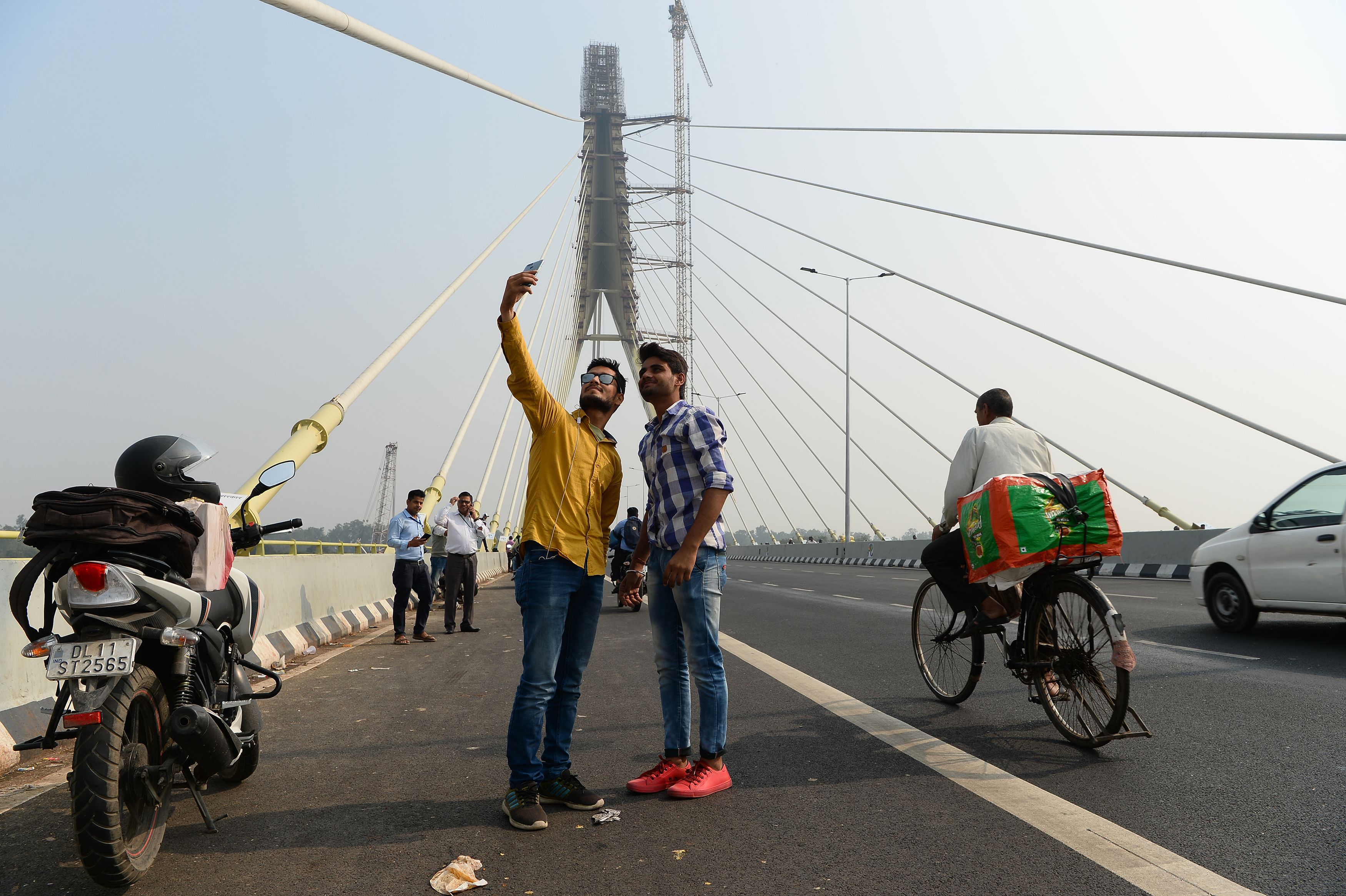 Indian youths take a selfie on the newly built Signature Bridge in New Delhi in 2018