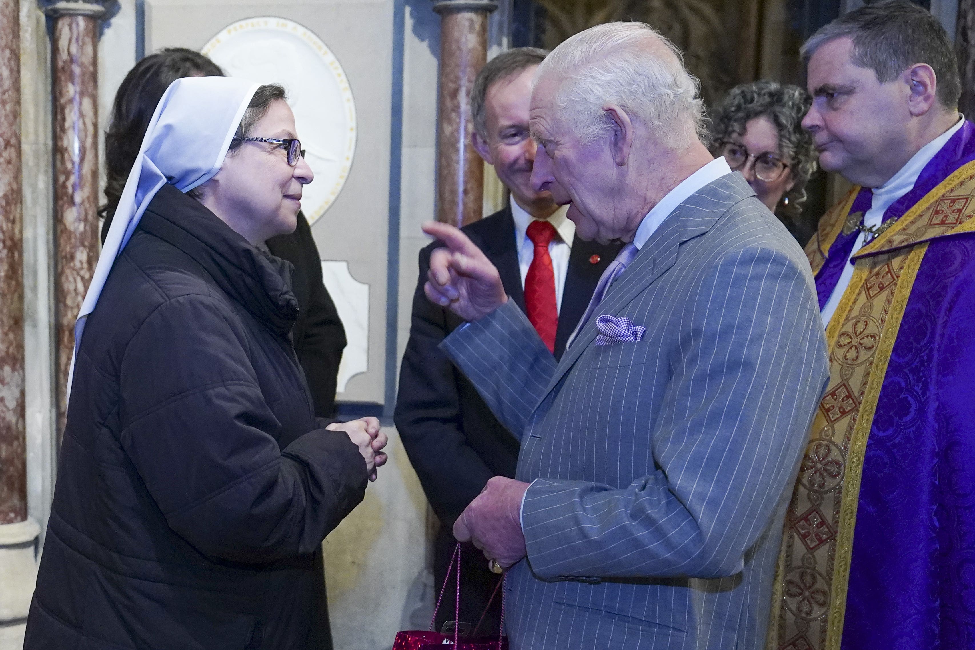 The King meets Sister Annie Demerjian during an advent service celebrating the strength and courage of faith communities at the Catholic Church of the Immaculate Conception, also known as Farm Street Church, in London (Arthur Edwards/The Sun/PA)