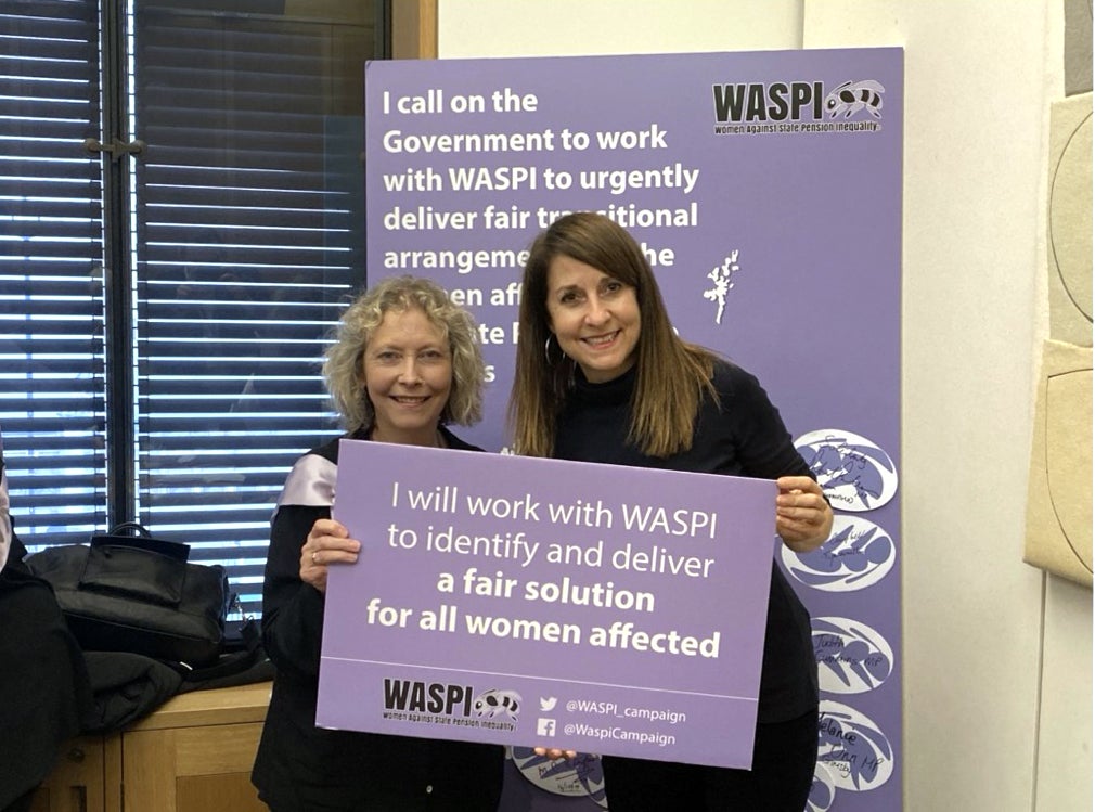 Secretary of State for Work and Pensions Liz Kendall (right) holding a placard in support of the Waspi campaign (Waspi/PA)