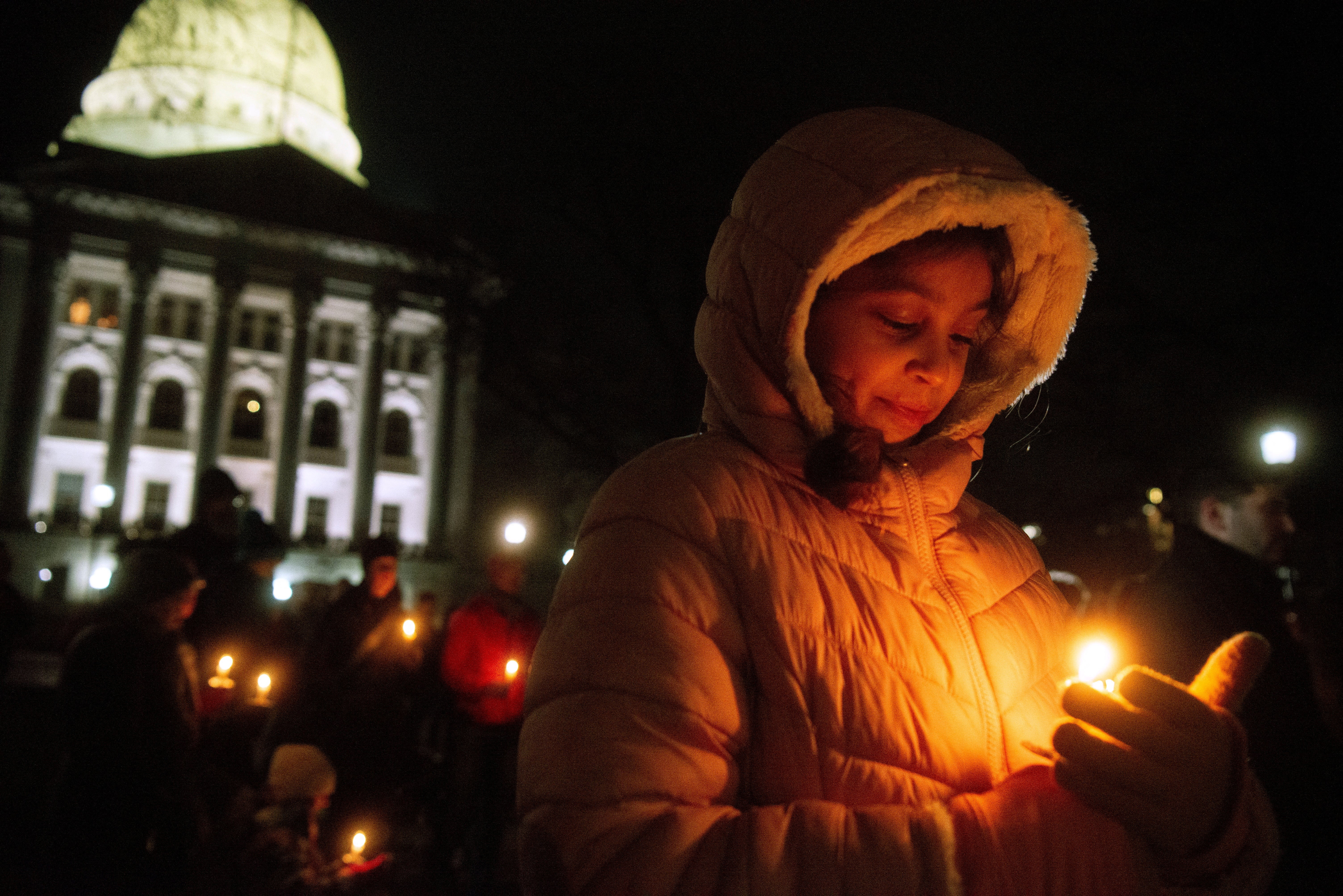 Mourners gather for a candlelight vigil at the Wisconsin State Capitol building a day after a shooting at Abundant Life Christian School, in Madison, Wisconsin. The shooting was an outlier from others in several ways including location