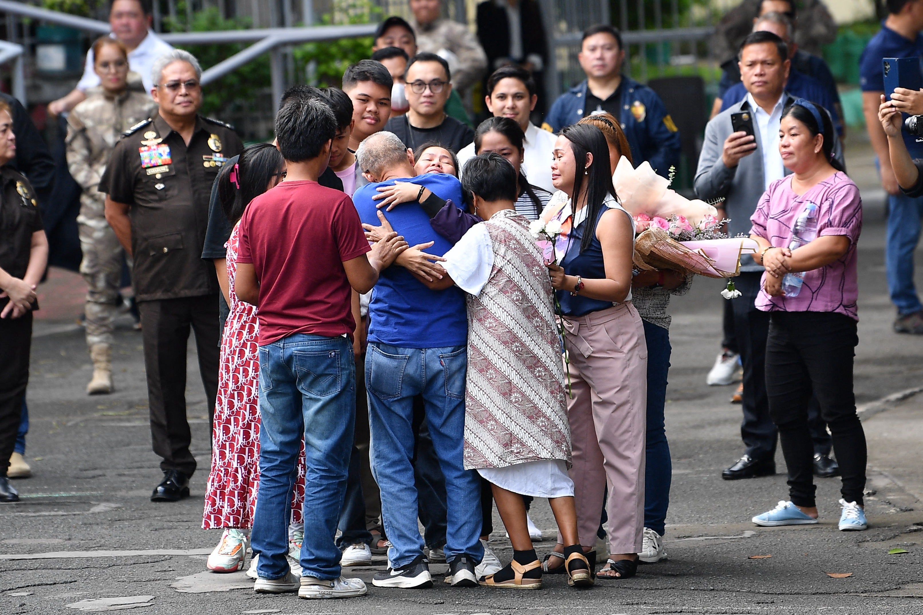 Mary Jane Veloso, facing camera, hugs her parents and children after arriving at the Correctional Institution for Women in Manila on 18 December 2024