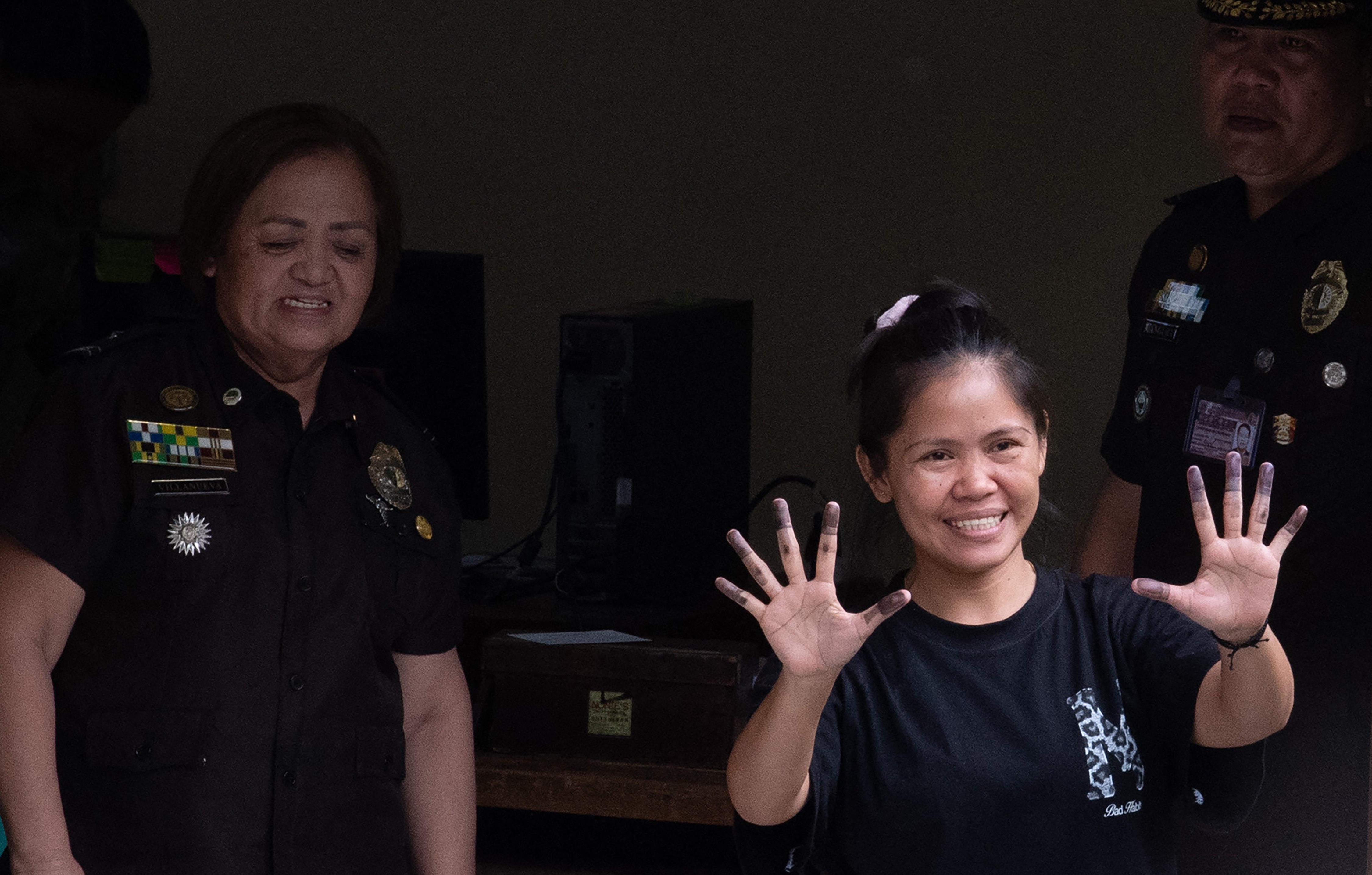 Mary Jane Veloso shows her inked fingers after giving fingerprints during a booking process at the Correctional Institution for Women in Manila on 18 December 2024