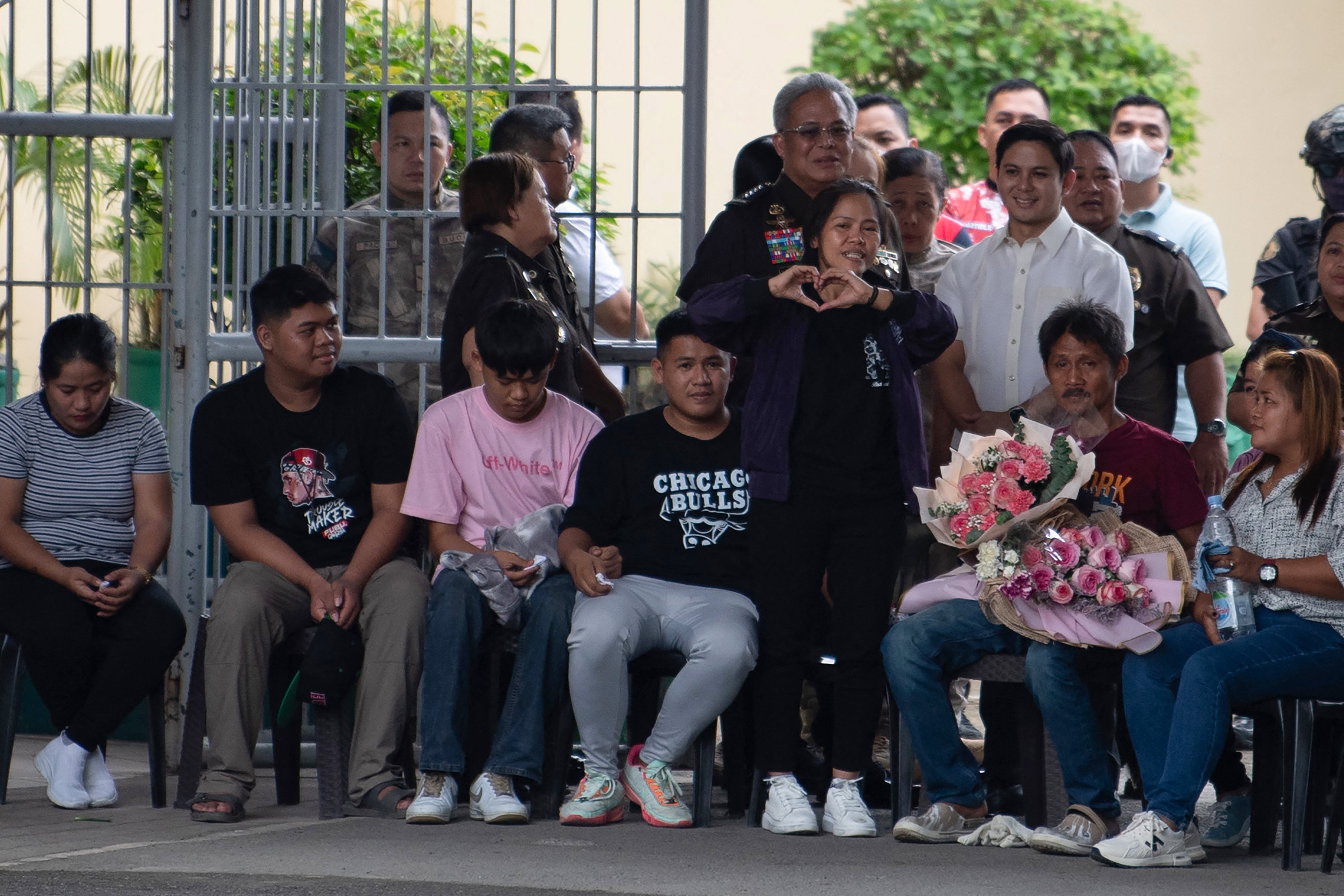 Mary Jane Veloso, standing, gestures as she meets her family after arriving at the Correctional Institution for Women in Manila on 18 December 2024