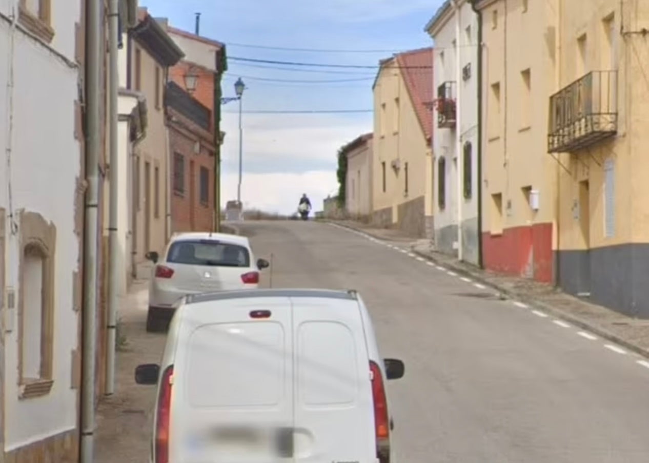 Another angle shows a man pushing a large white package in a wheelbarrow