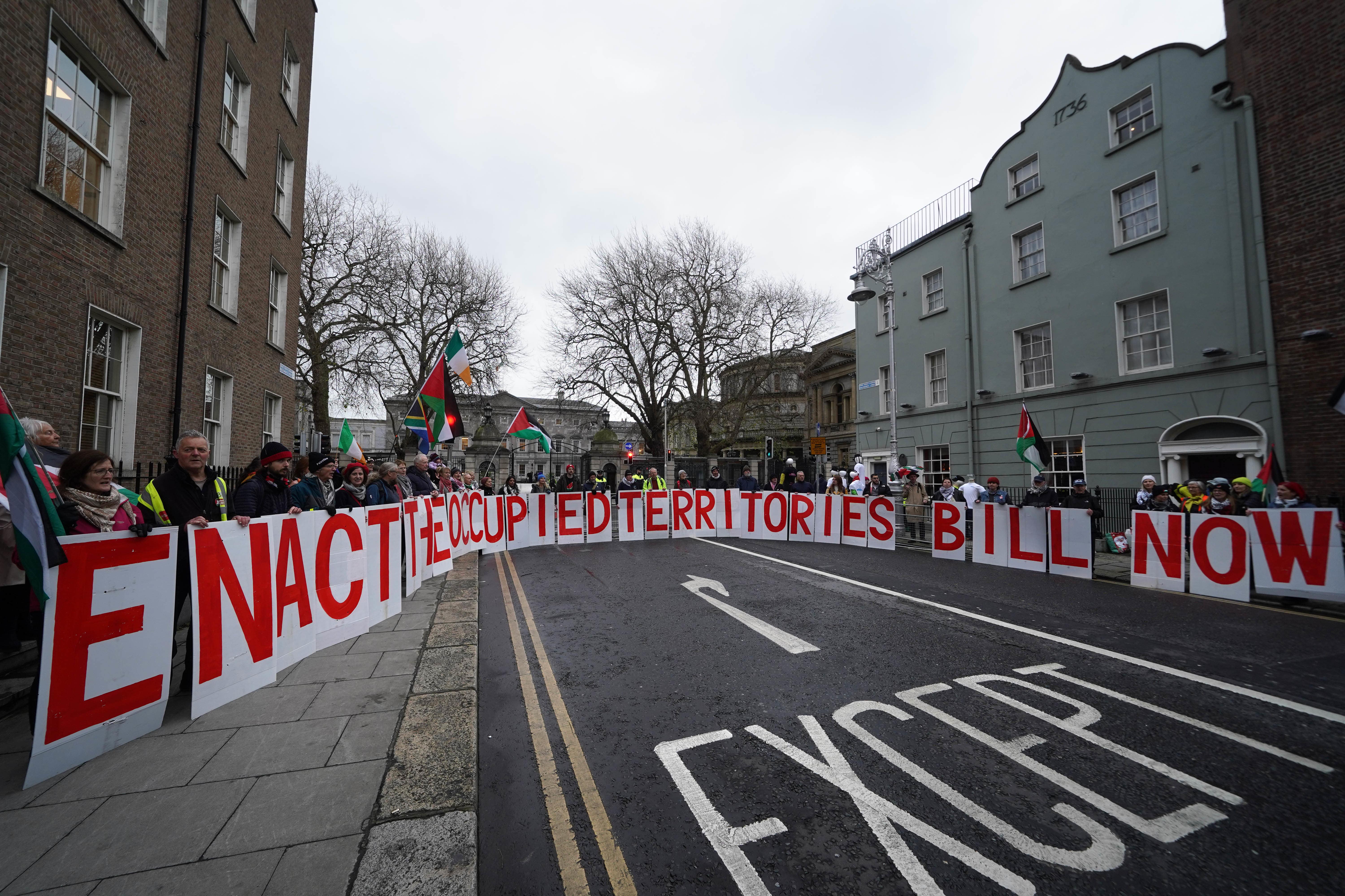 Protesters outside Leinster House in Dublin ahead of the first sitting of the new Dail since the Irish general election. The 174 TDs will vote by secret ballot to elect a new Ceann Comhairle (speaker). Picture date: Wednesday December 18, 2024.