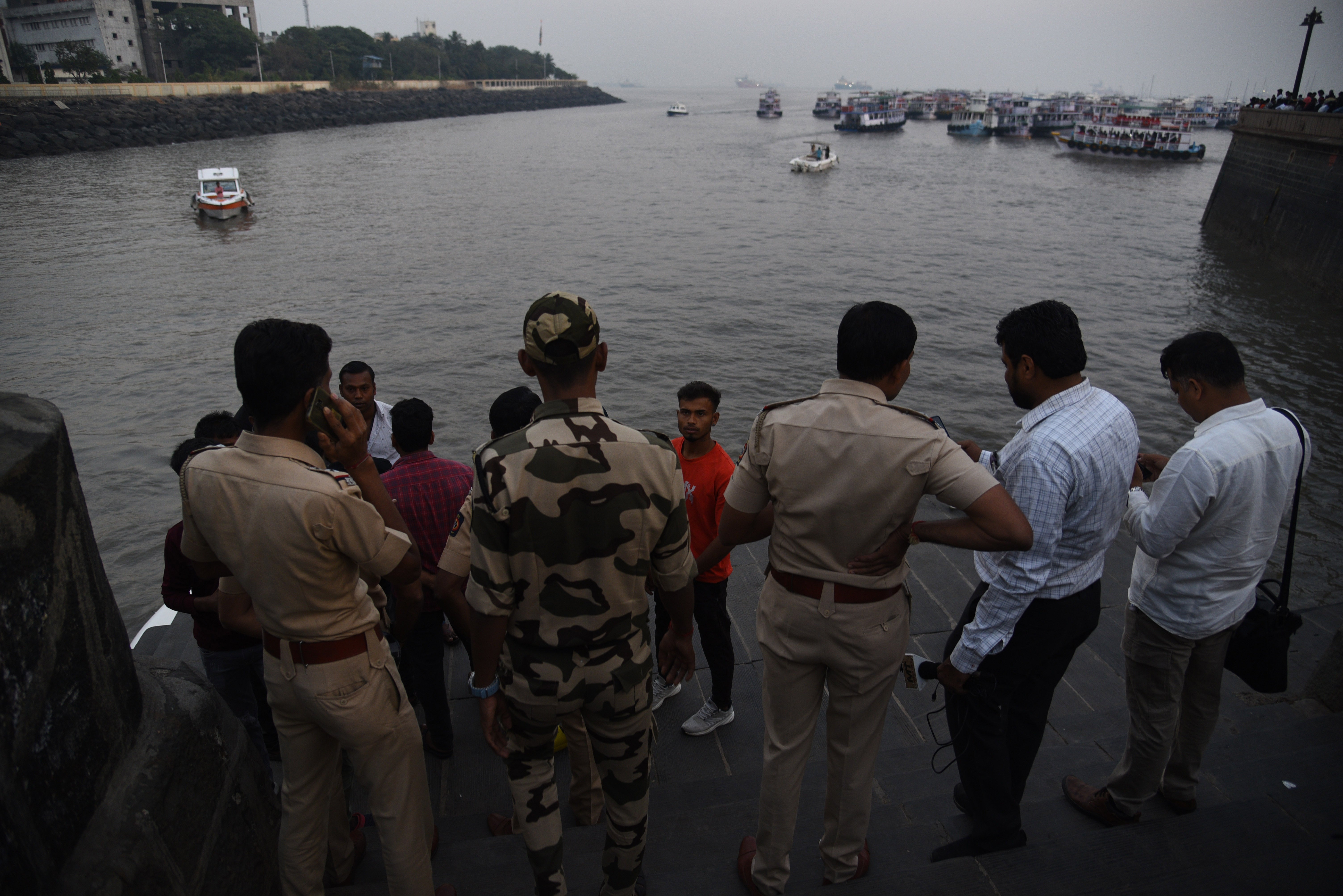 Passengers who were rescued after a boat that capsized off the coast in Mumbai, India on December 18