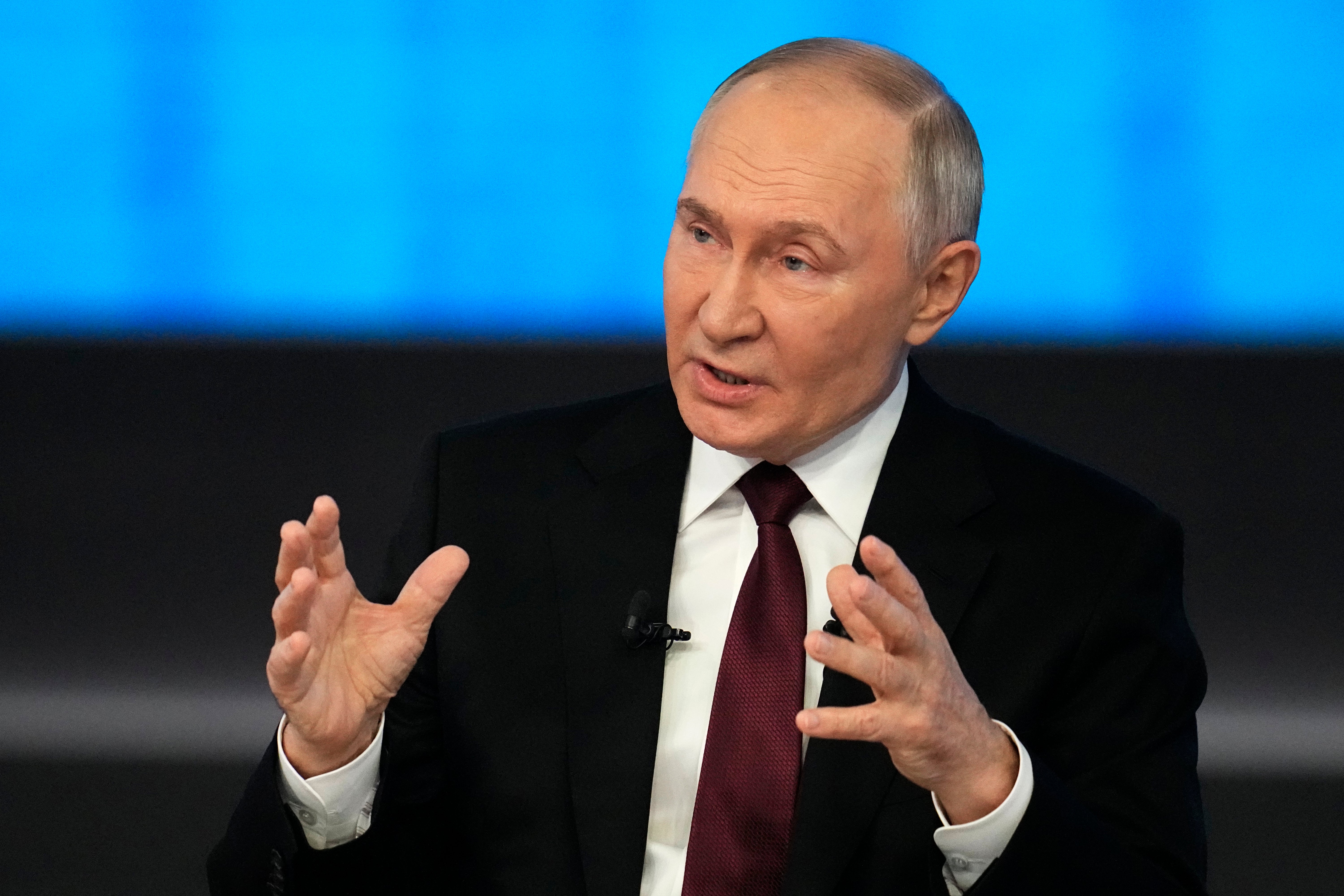 Putin speaking to reporters during the annual marathon TV event