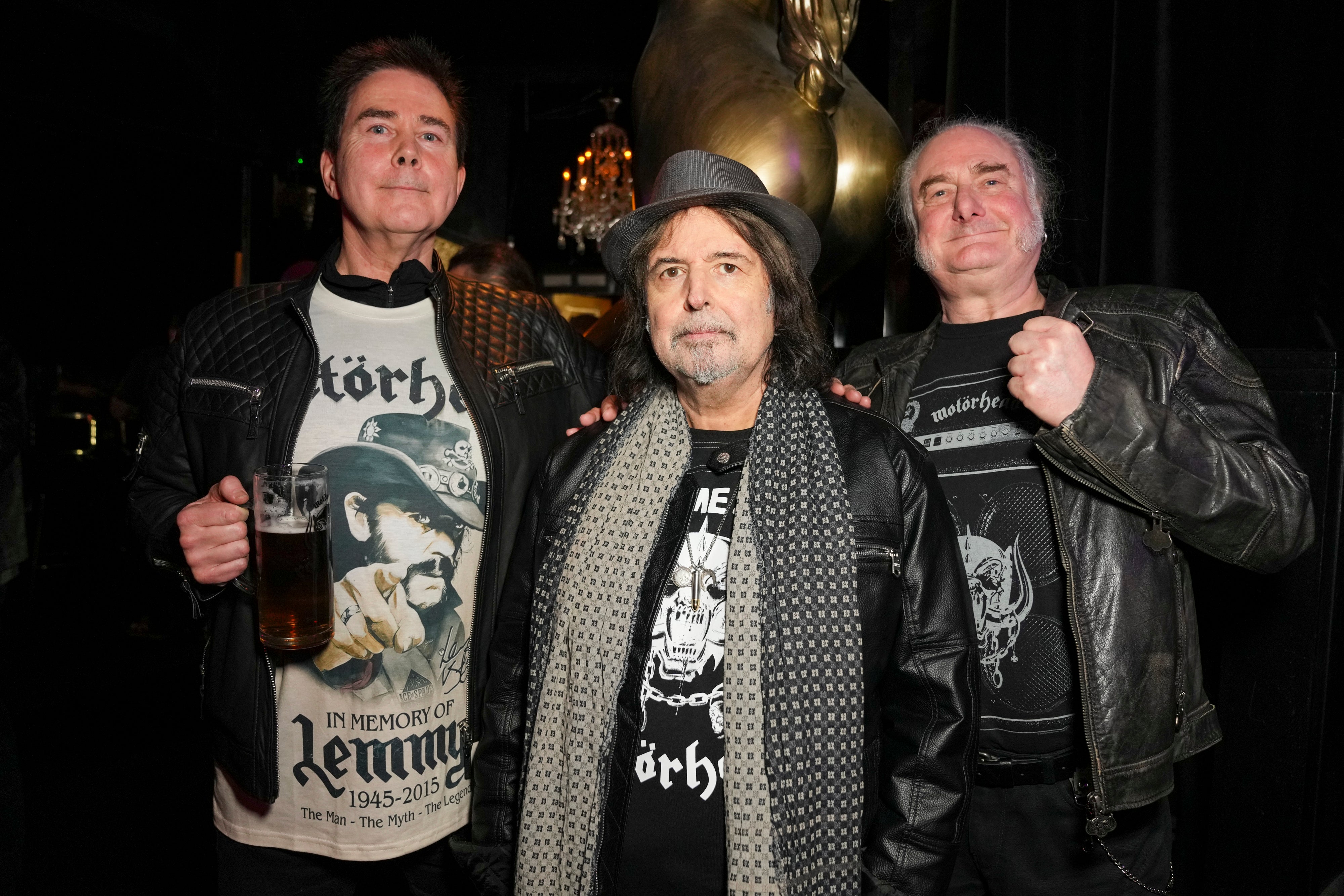 Robert Kiewik, Phil Campbell and Mick Stevenson posing at Stringfellows nightclub in London