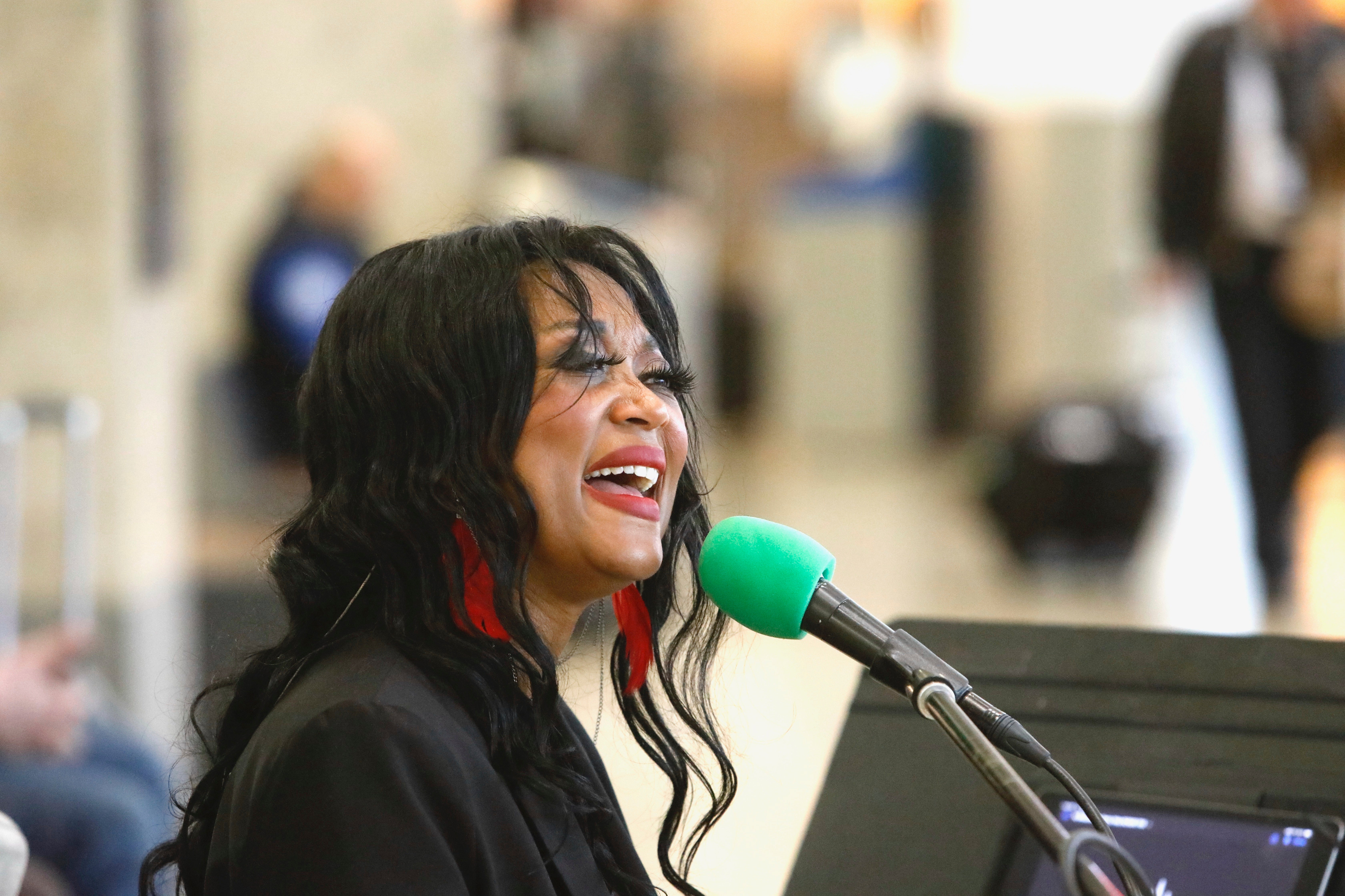 Roz McCommen sings at Seattle-Tacoma International Airport on November 26