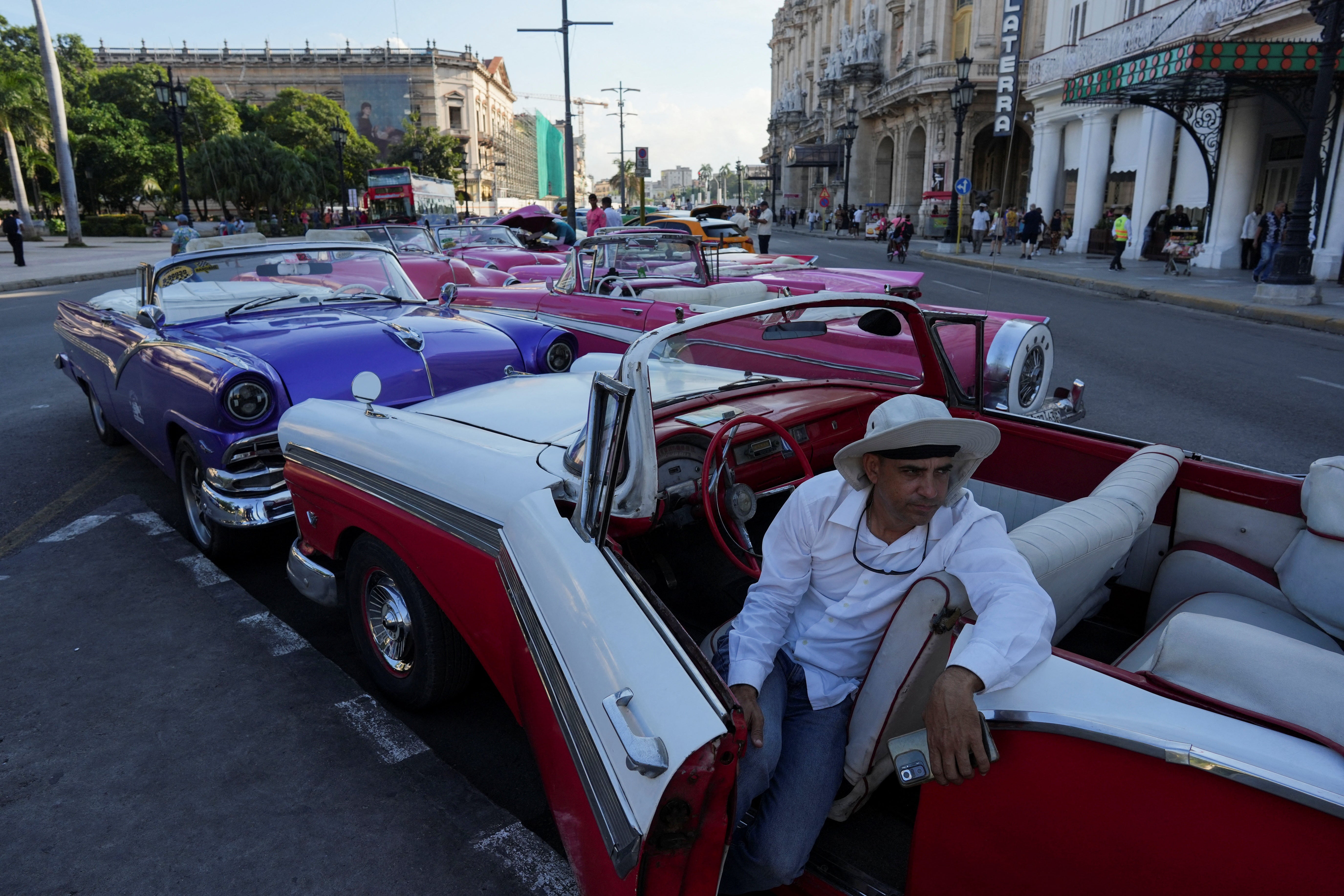 A vintage car driver waits for tourists in downtown Havana, Cuba, December 18