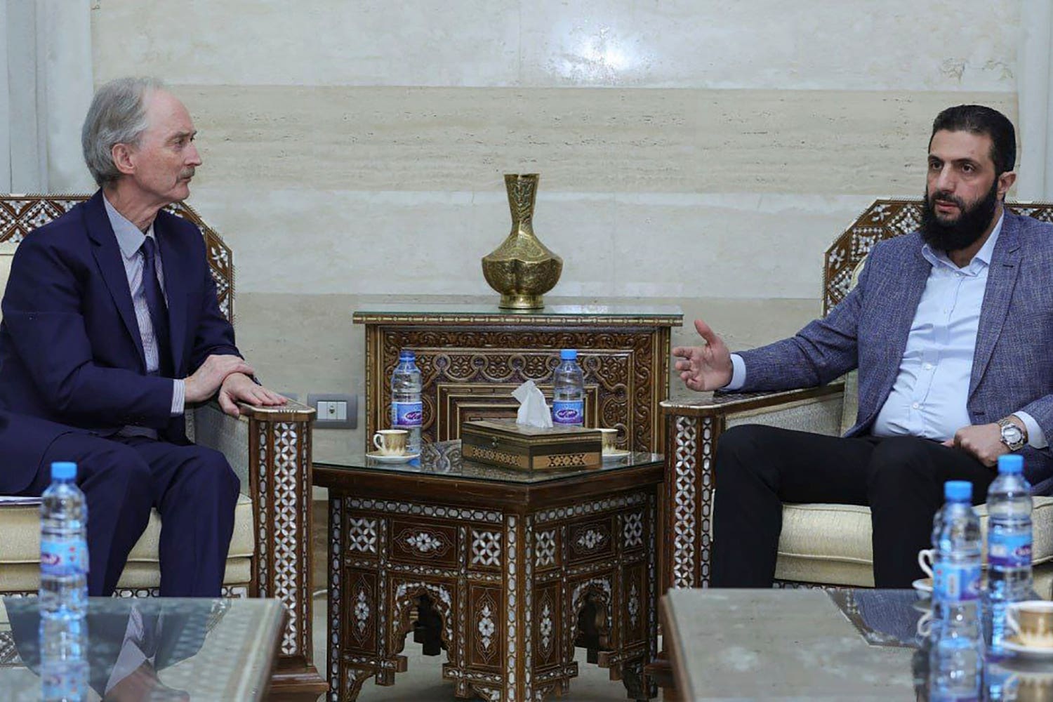 The leader of Hayat Tahrir al-Sham, Ahmad al-Sharaa, (Abu Mohammed al-Golani), right, as he meets with the United Nations’ special envoy to Syria, Geir Pederson, in Damascus (SANA/AP)