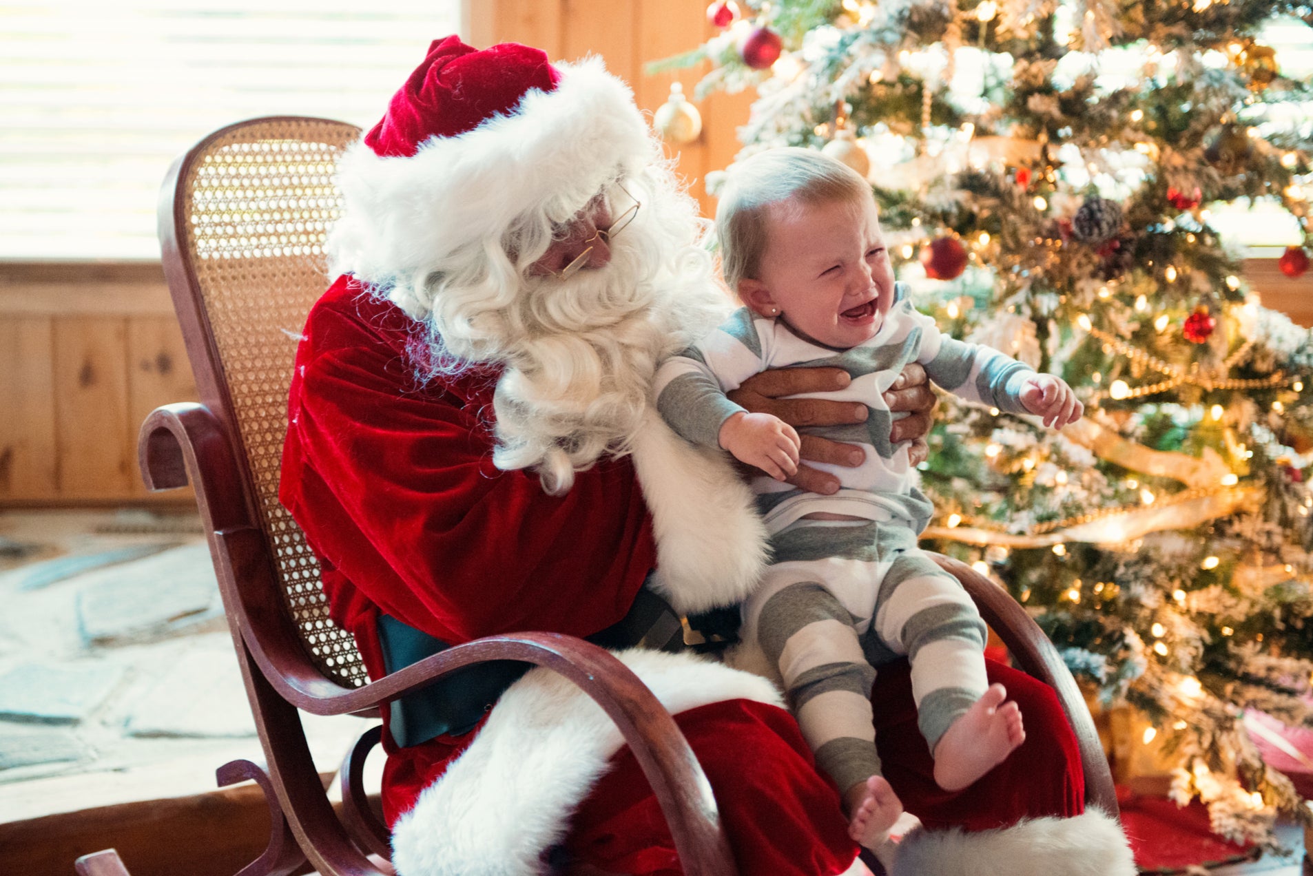 A baby weeps in Santa’s lap (presumably they sense they are being lied to)