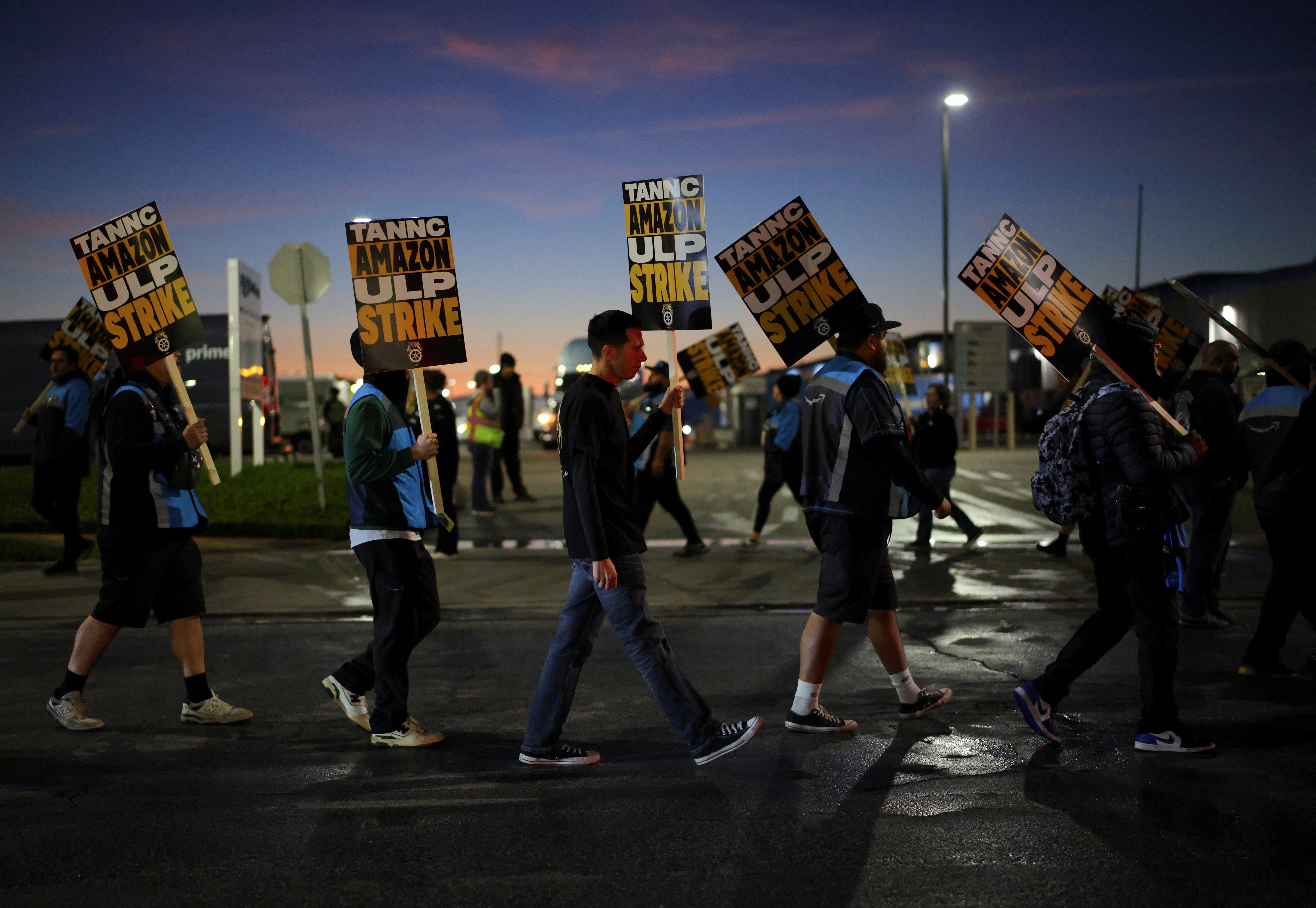 Striking workers picket outside of the Amazon DAX5 warehouse, in City of Industry, California,