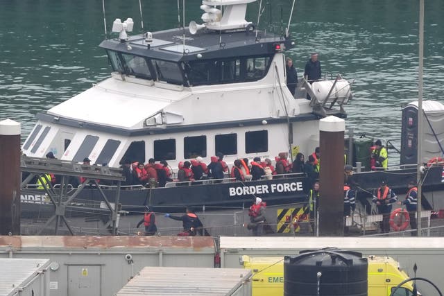 <p>A group of people thought to be migrants are brought into Dover, Kent, from a Border Force vessel</p>