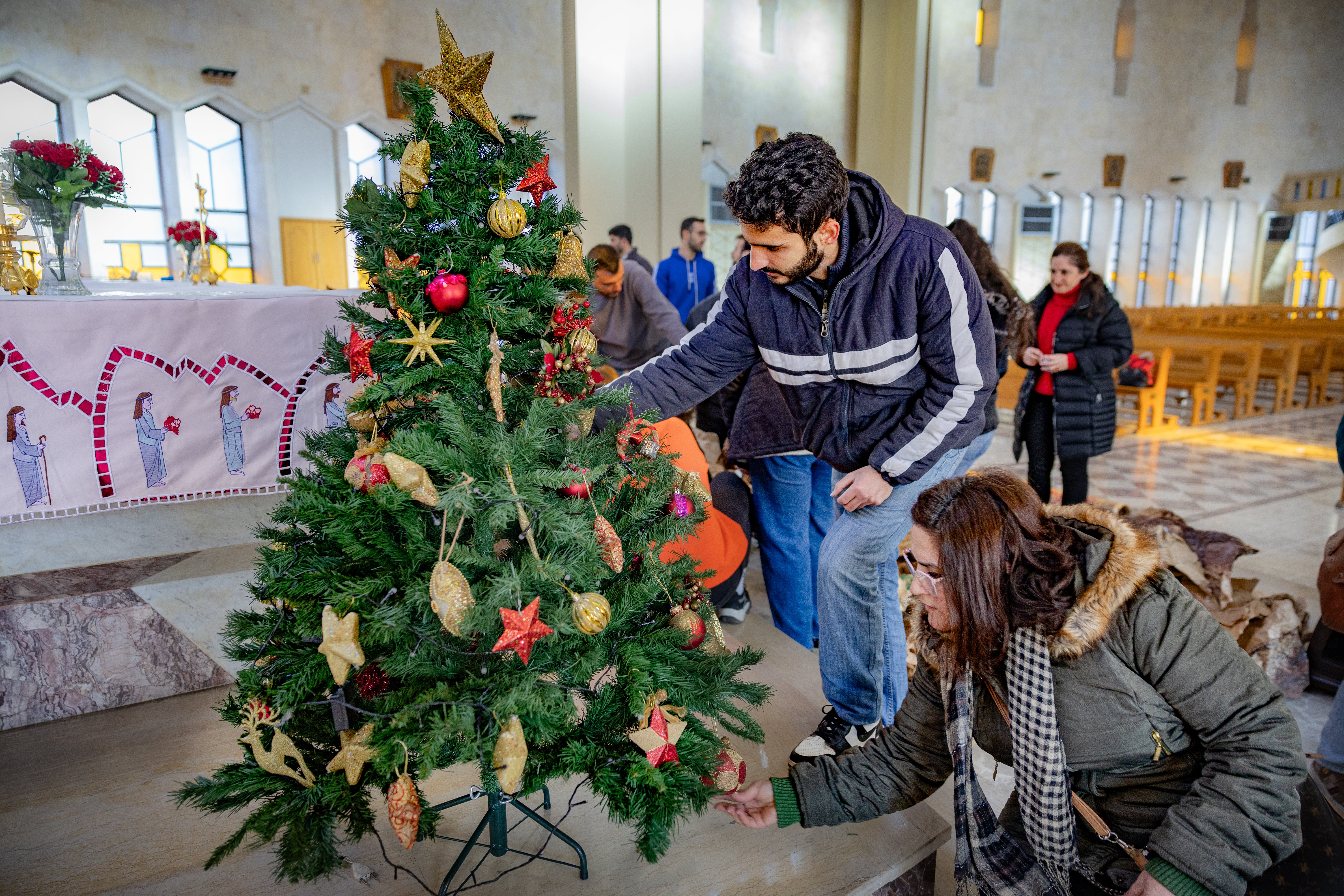 The congregation of Aleppo’s Cathedral of Our Lady of Assumption decorate the Christmas tree and build the nativity