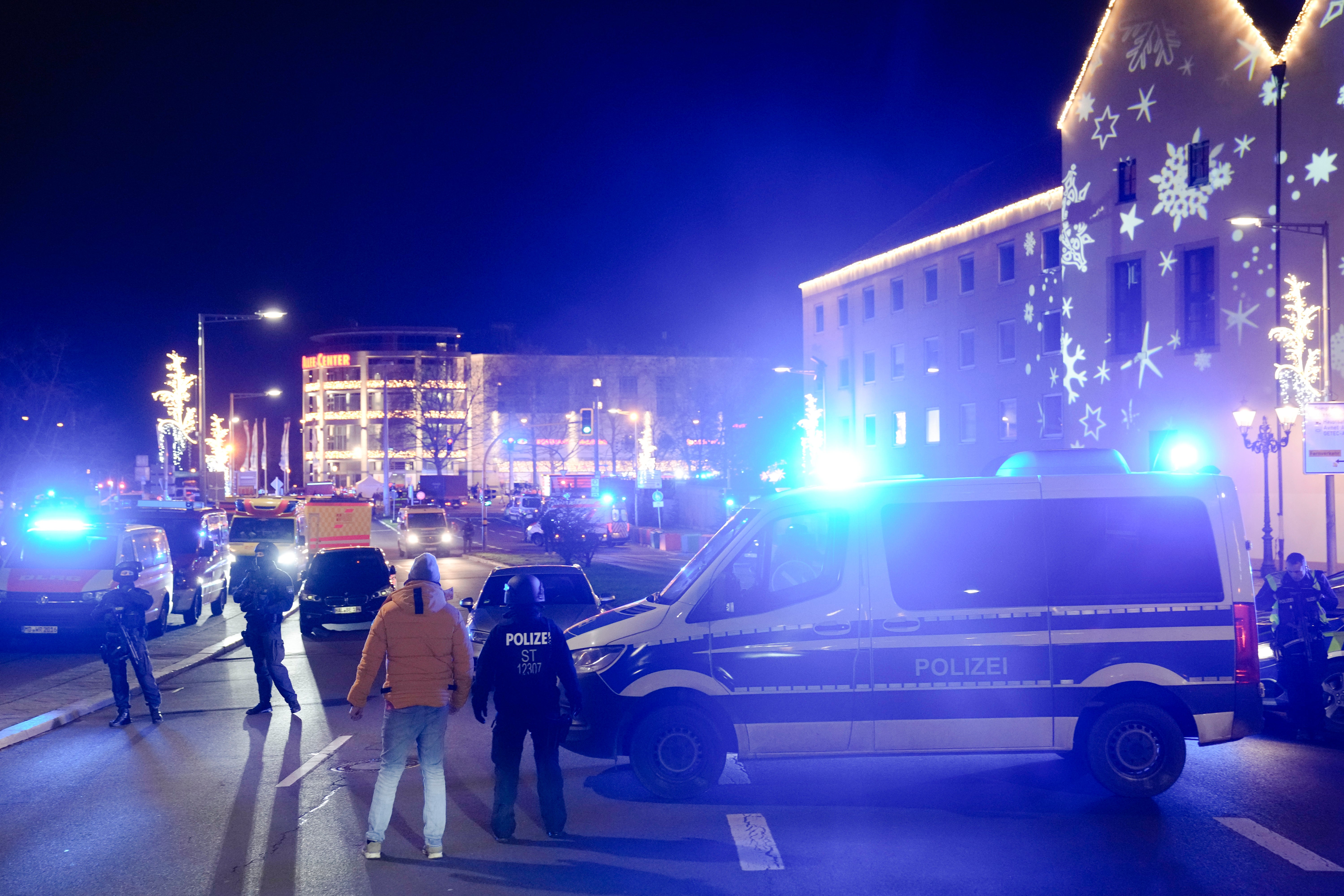 Police officers guard at a cordoned-off area near the Christmas Market